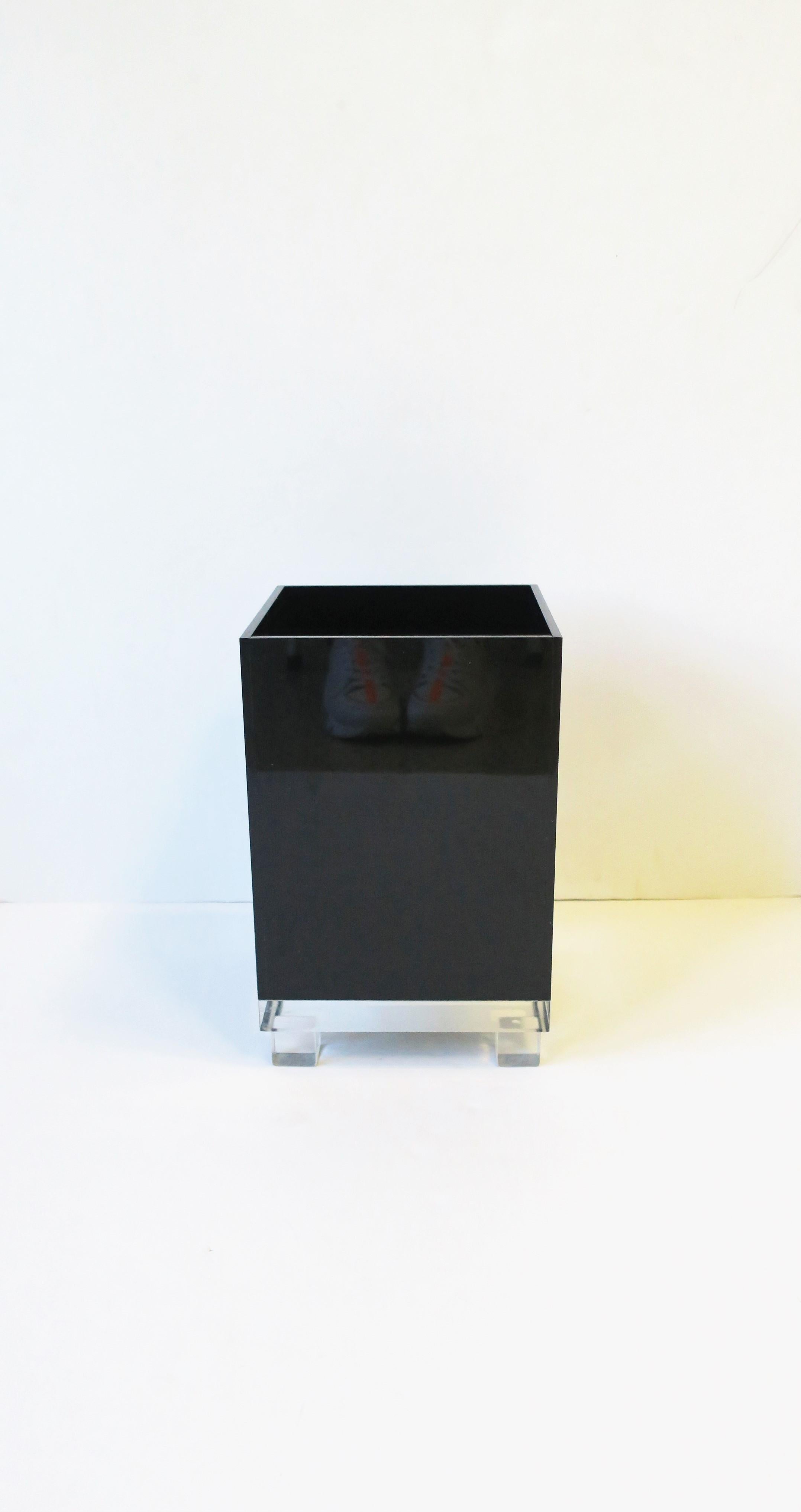 A Modern style black acrylic and Lucite wastebasket or trash can attributed to designer Stephanie Javits, circa late-20th century, USA. A great piece for an office, library, bathroom, etc. Dimensions: 7.94