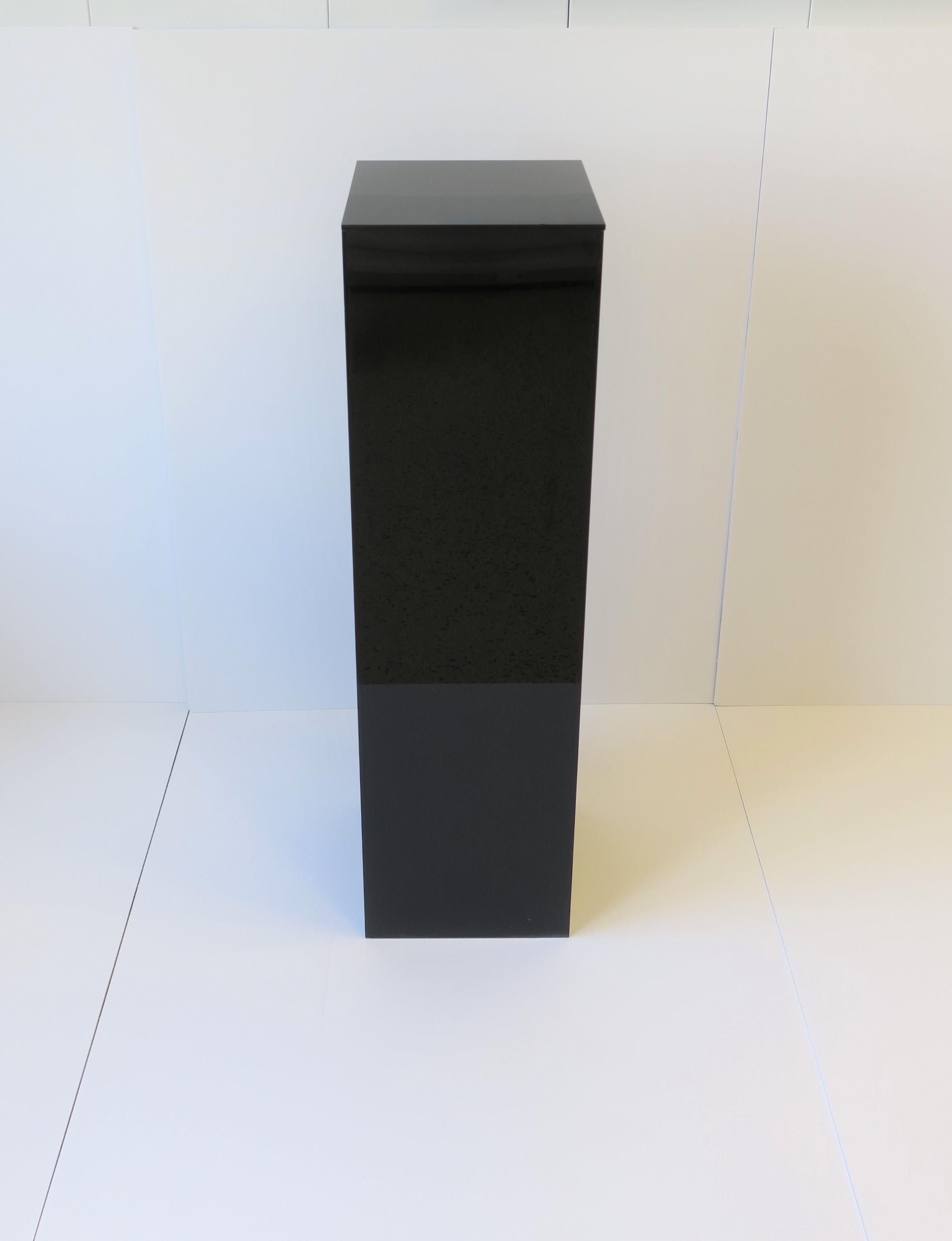 A tall rectangular black acrylic pedestal column stand display piece for items such as art, sculpture, jewelry, plant and more. 

Measurements include: 10