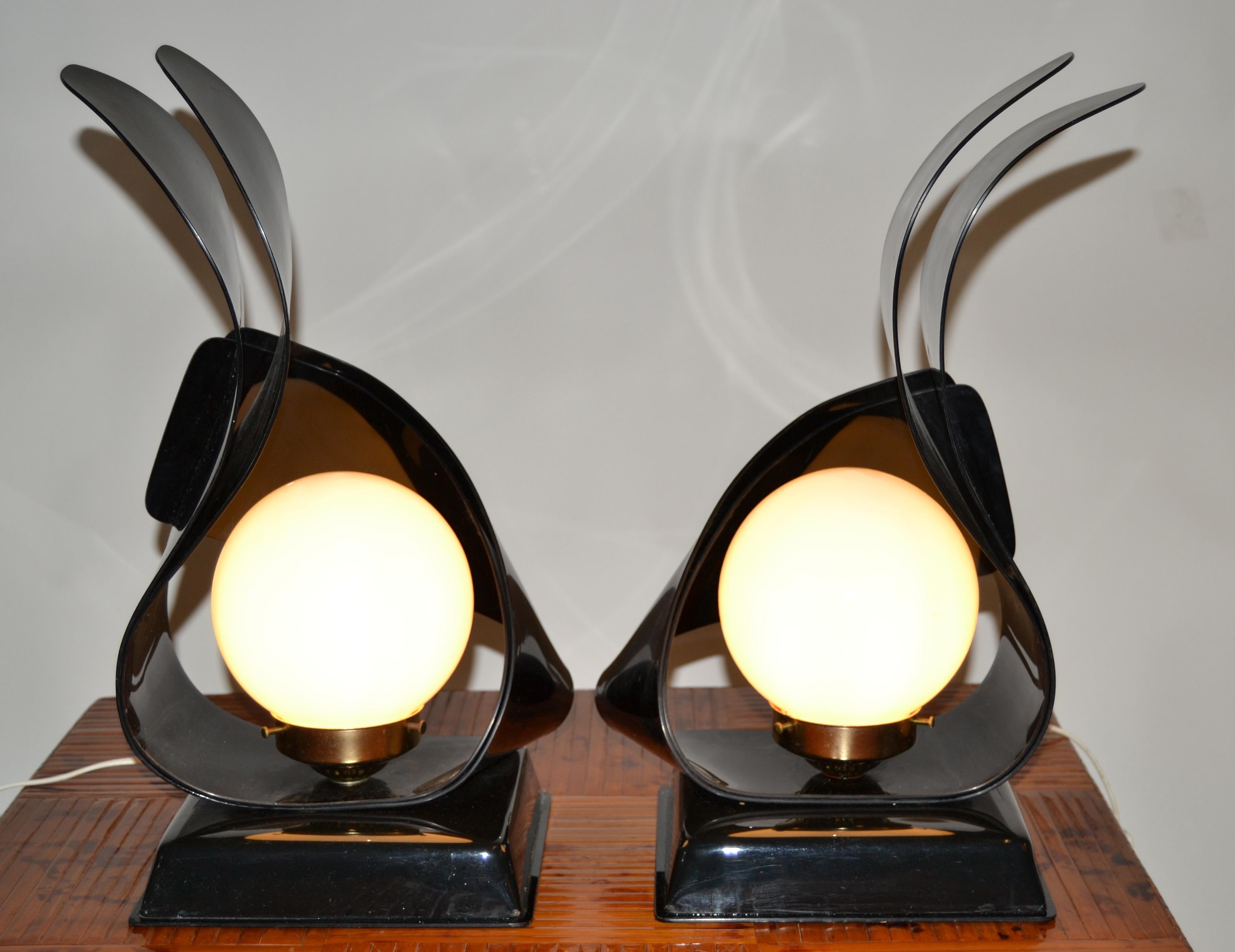 A pair of black acrylic sculptural table lamps by acrylic design.
Each Lamp has a milk glass globe and takes one max. 40 watts light bulb.
In perfect working condition and wired for the U.S.
Priced for the Pair. 
 