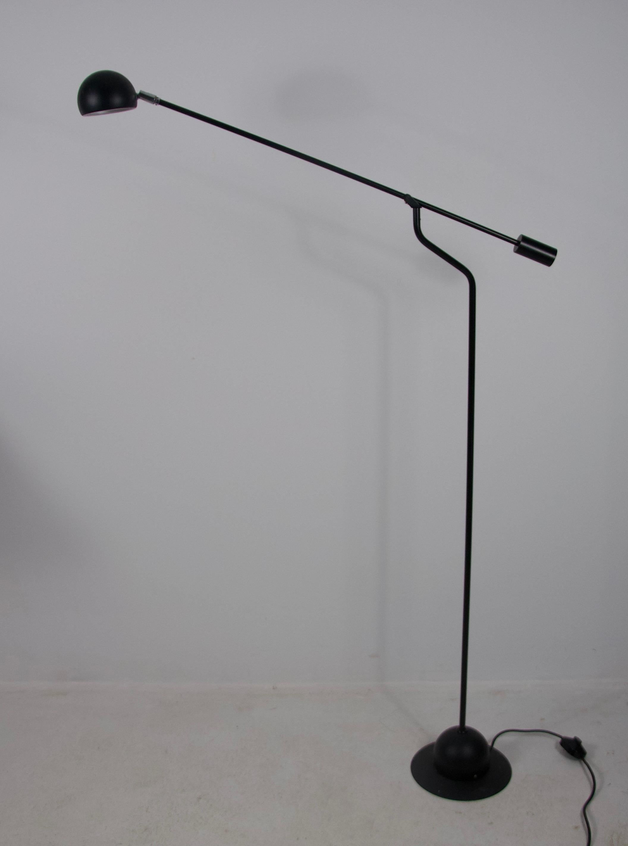 This elegant black floor lamp from 1970s Germany combines timeless design with functional sophistication. Featuring a sleek, angular frame and a matte black metal finish, it reflects the minimalist aesthetic of the era, strongly influenced by the