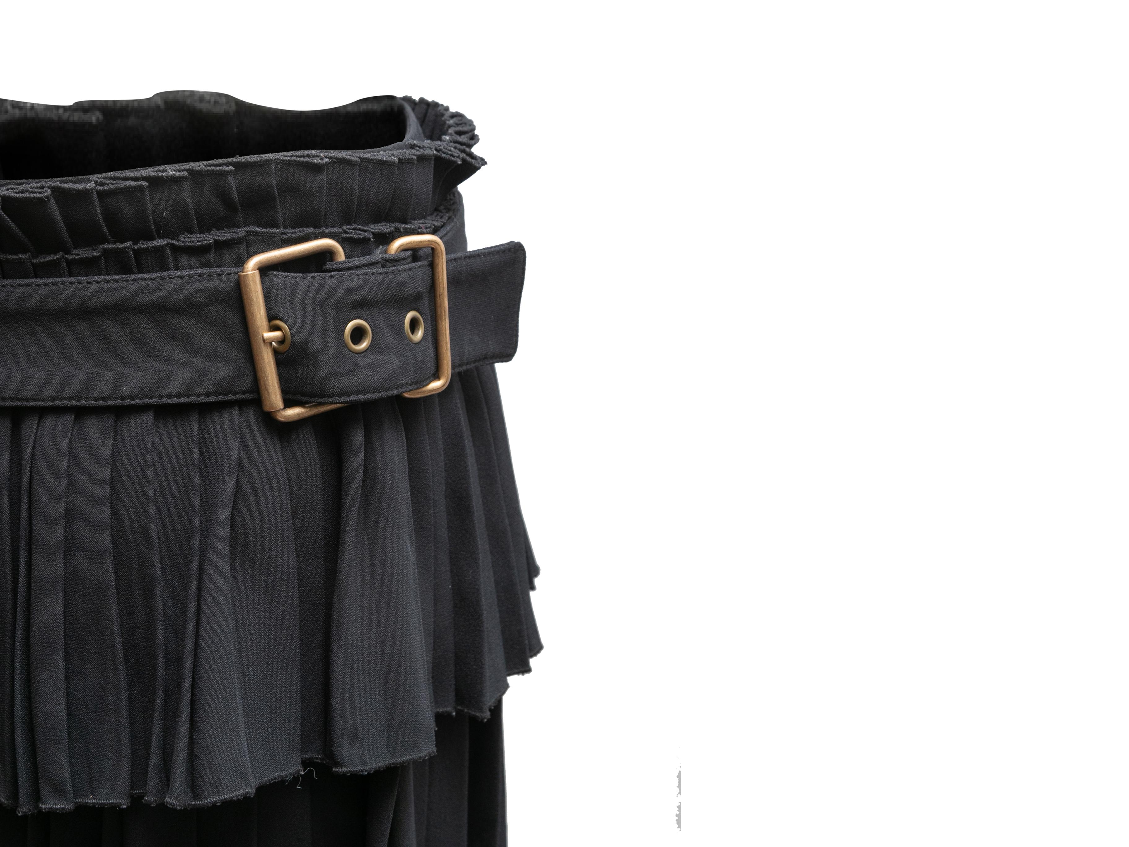 Black pleated mini skirt by Alexander McQueen. Snap closures at back and buckle closure at waist. 32