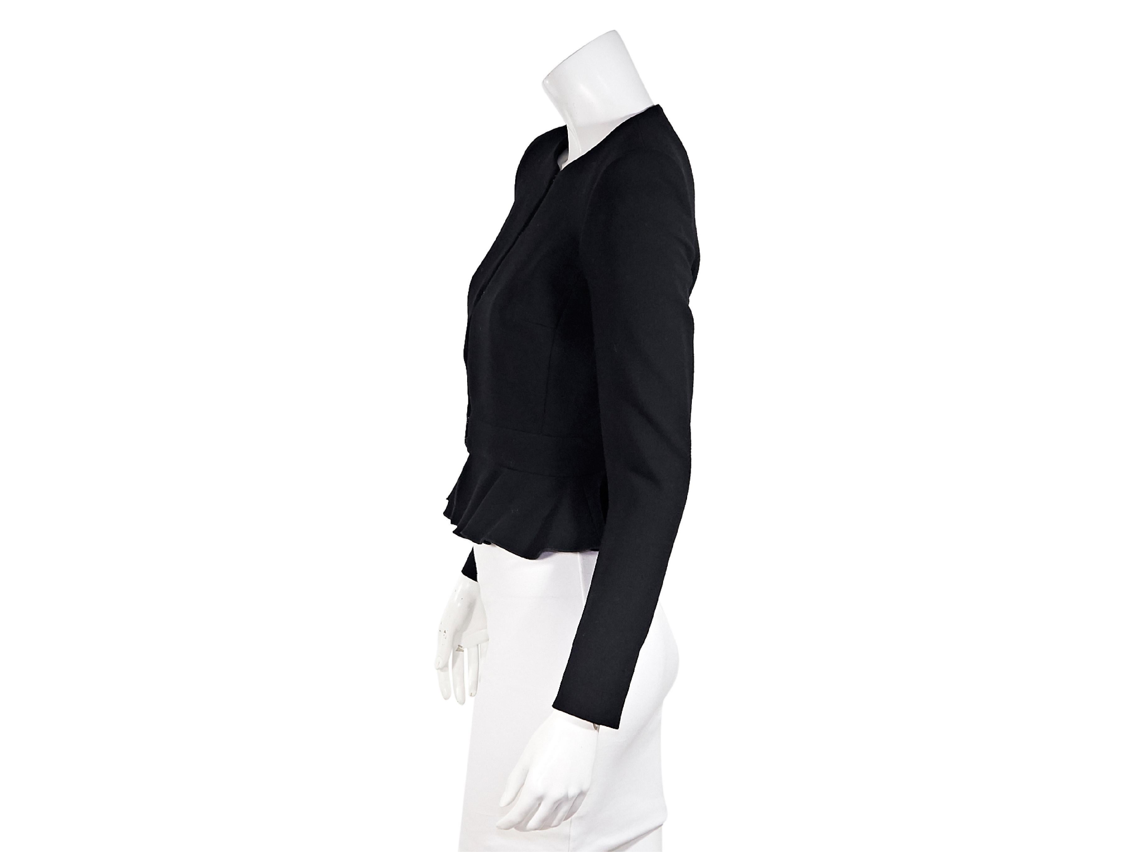 Product details:  Black silk moto jacket by Alexander McQueen.  From the FW 2003 collection.  Stand collar.  Long sleeves.  Zip-front closure.  Ruffle panels.  34