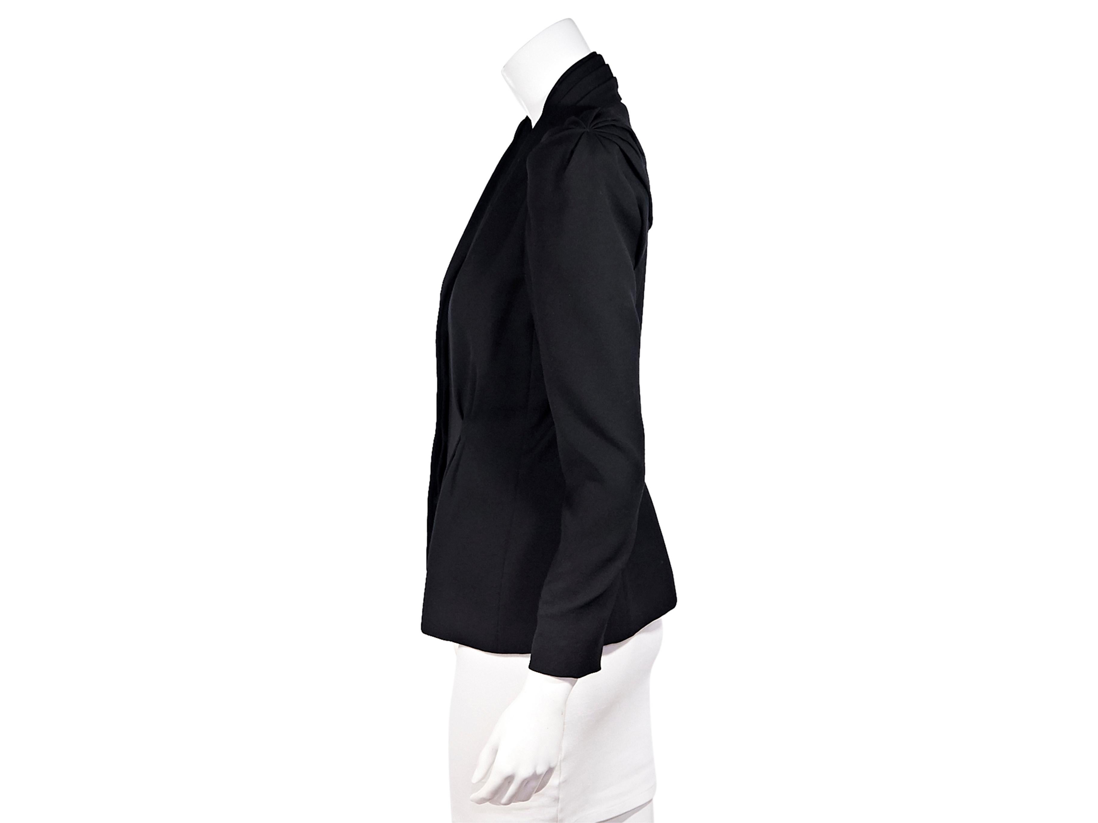 Product details: Made in Italy, this Alexander McQueen blazer is tailored from lamb's wool with structured shoulders and pin-tuck details at the front and concealed button fastenings through the front. Draw attention to the shawl collar with