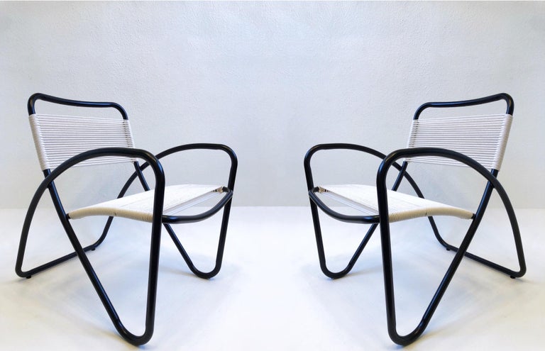 Set of four 1970’s sculptural black powder coated aluminum outdoor lounge chairs by Brown Jordan. 
Newly powder coated satin black and new cotton cord. 
Measurements: 24.5” Wide, 29” Deep 31.25” High, 16.75” Seat, 23.75” Arm.