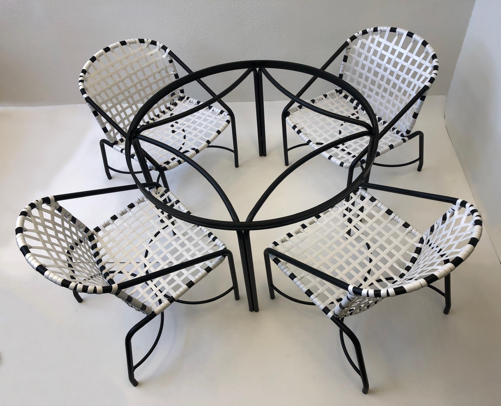 1950’s iconic “Kantan” Patio set design by Tadao Inouye for Brown Jordan.
The set has be newly professionally restored. 
Constructed of black powder coated aluminum and white vinyl straps.
Original glass top, shows minor wear consistent with age.