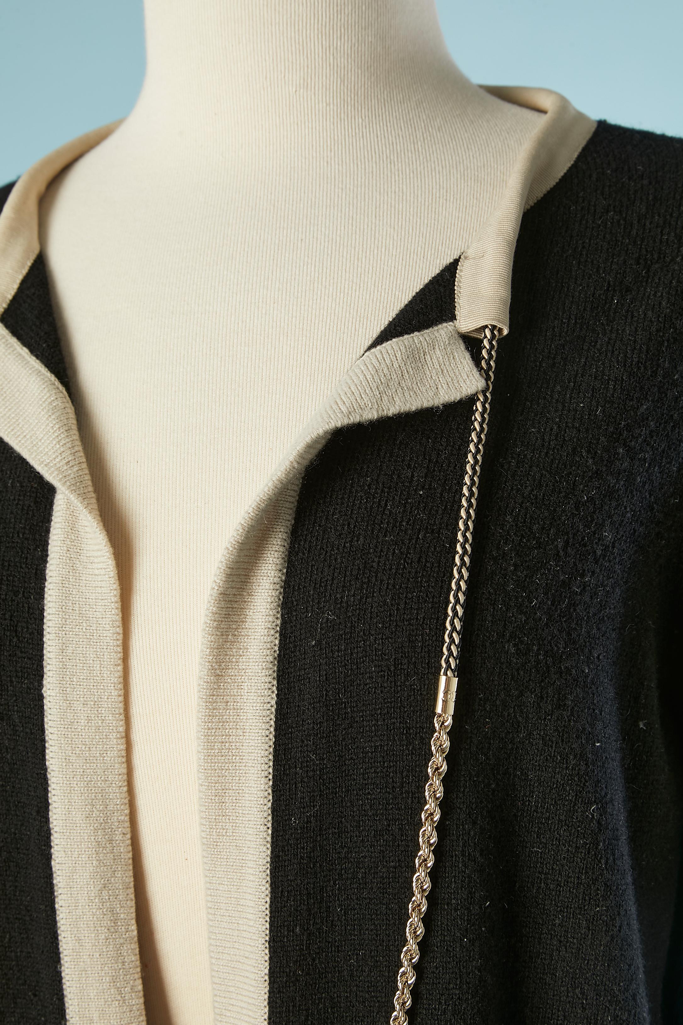 Black and beige cashmere cardigan with chain-neckless. Chain is a mix of metal and polyester string. Can be detachable. Small metallic 