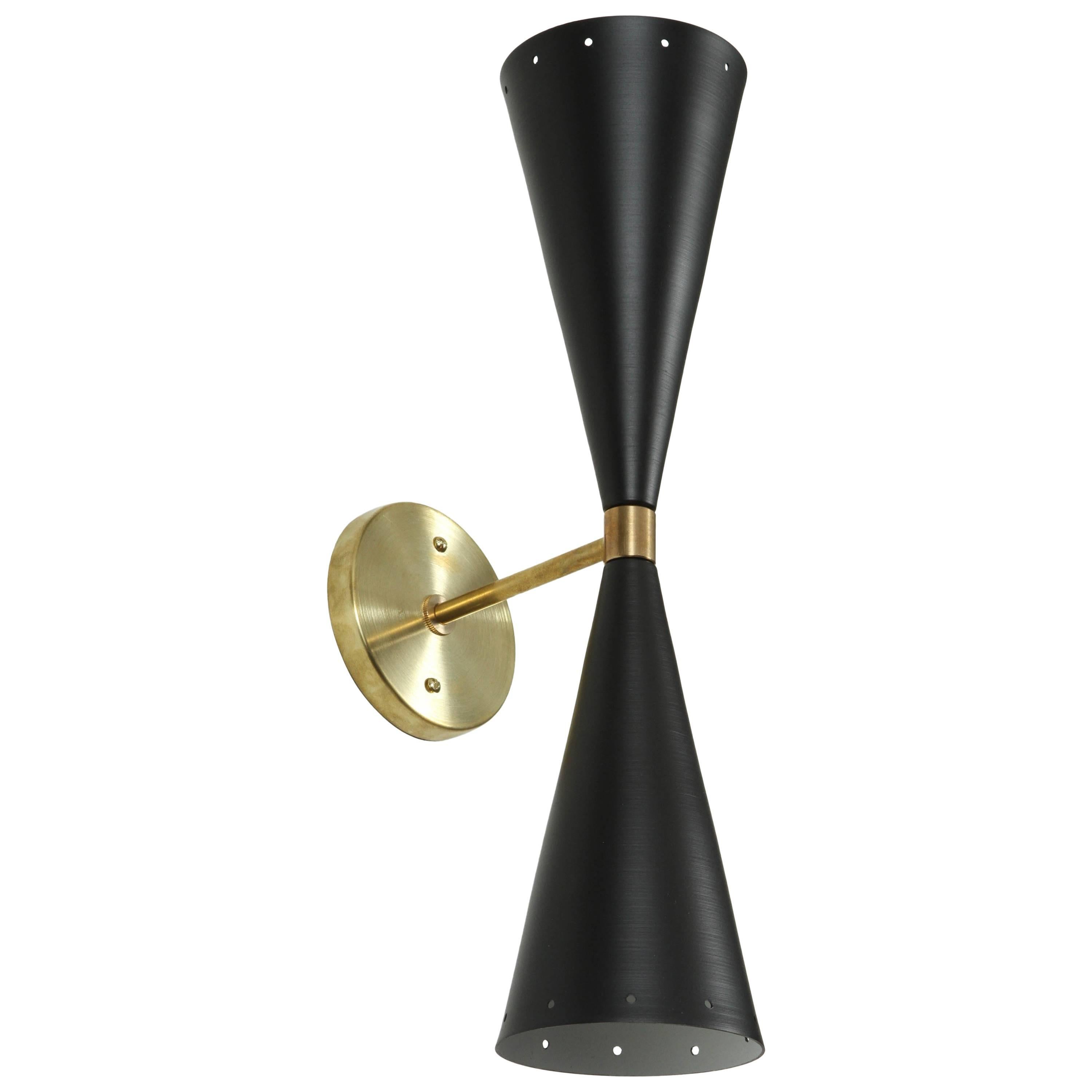 Black and Brass Double Cone Sconce by Lawson-Fenning. The double cone sconce features two tapered cones, in either black or white, with small perforations at both ends with a brass backplate and spacer. 

The Lawson-Fenning Collection is designed