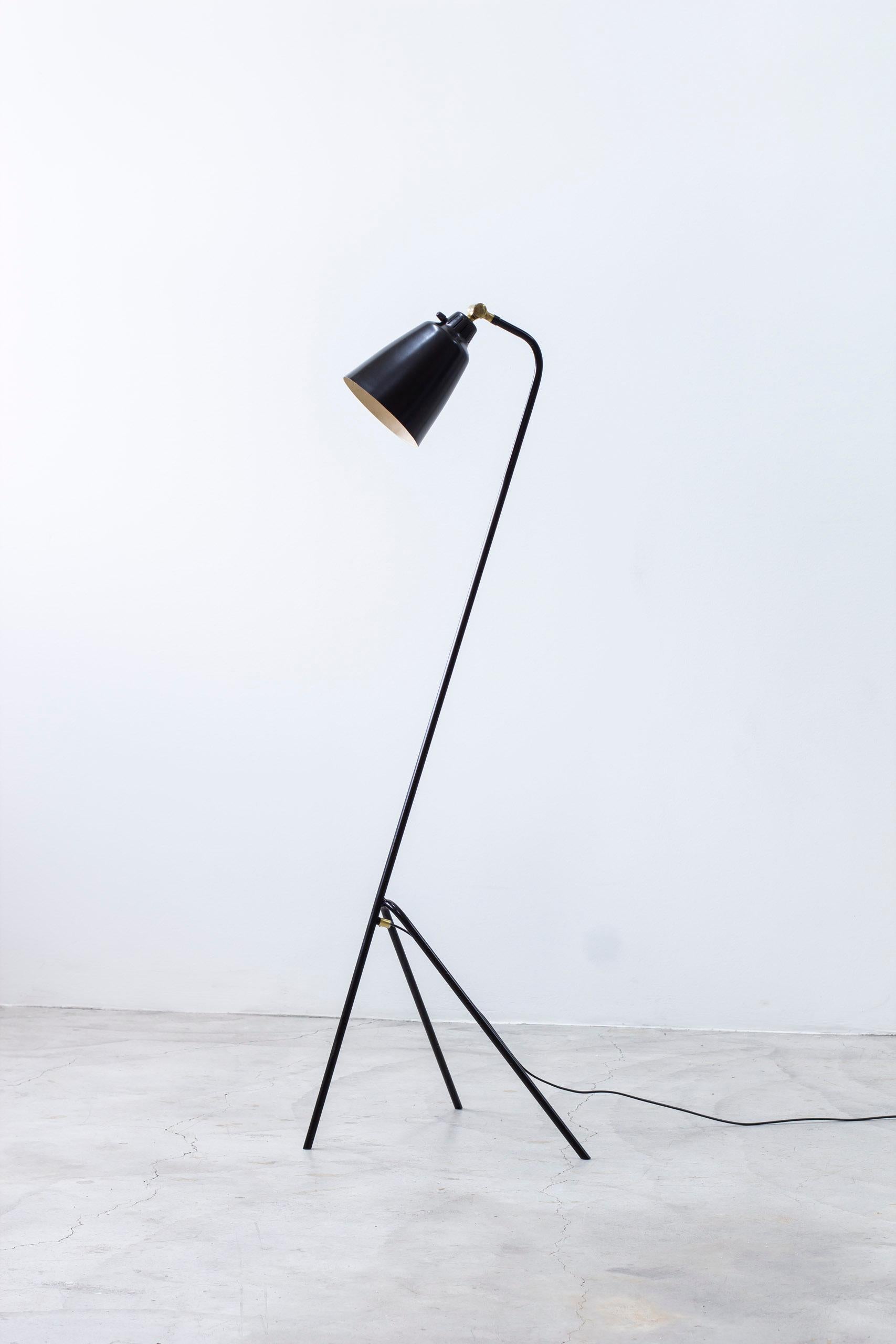 Floor lamp model 53701 produced by Uppsala Armaturfabrik. Made in Sweden during the 1950s. Black lacquered metal with brass details and bakelite turn switch. The lamp shade is adjustable from a reading light to an uplight. Good vintage condition