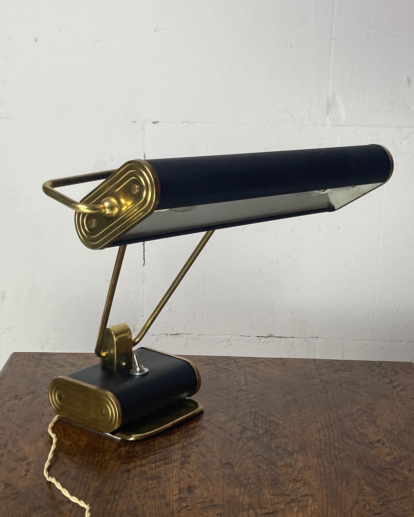 The iconic model n71 or jumo in the most coveted version in black with gold brass details. This desk lamp is in good condition considering its age, this is also one of the earliest editions with the metal on and off switch which later was produced