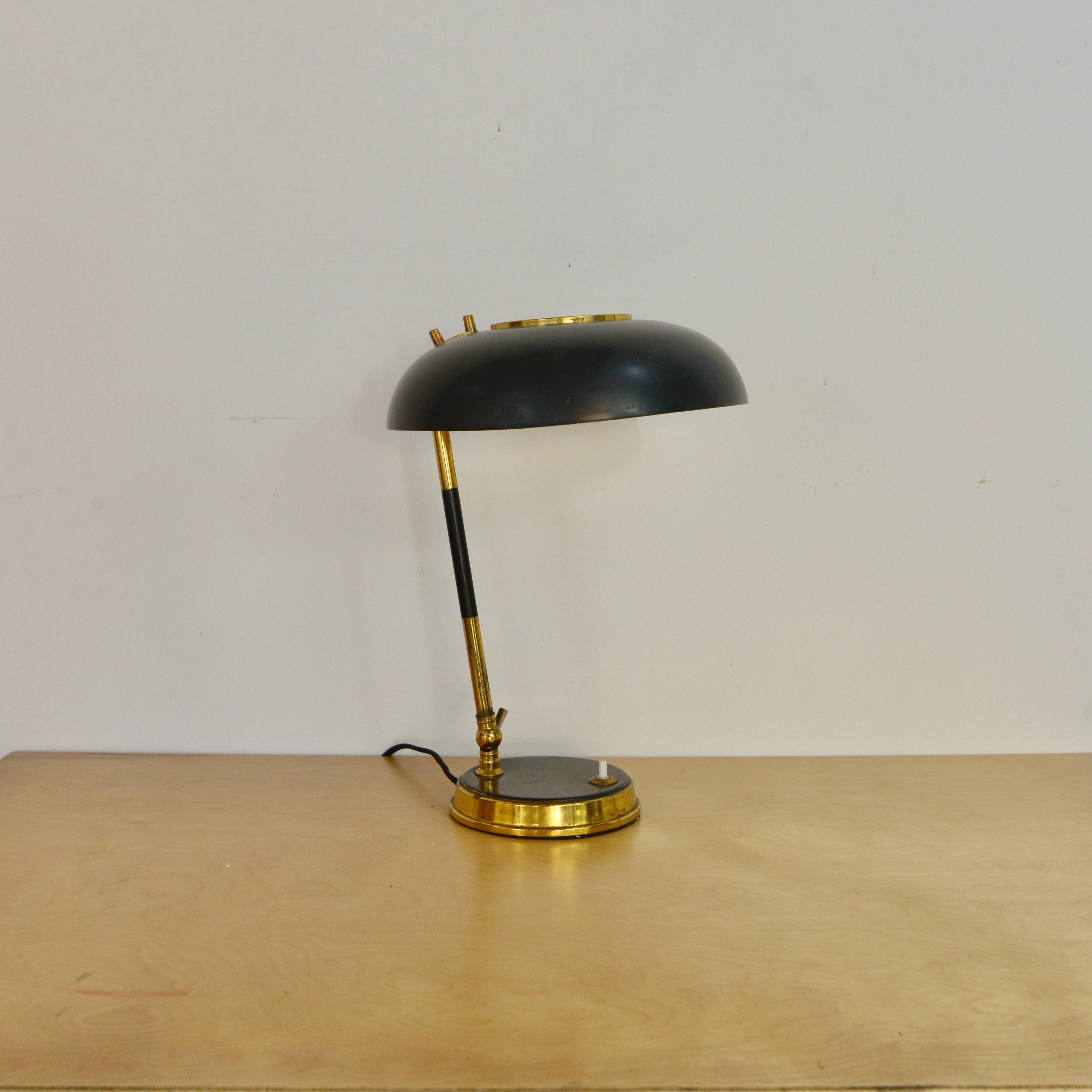 Fantastic black and brass Italian table lamp from Oscar Torlasco from the 1950s. Naturally aged brass. Shade and stem adjust for angling of light. Fully rewired for the US with a single E26 medium based socket. 
Measurements:
Height 13”
Diameter