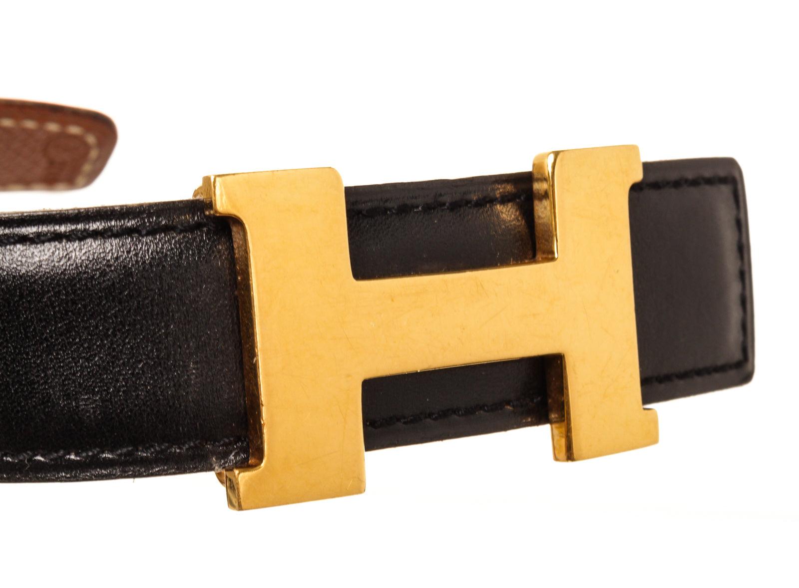 Black and brown leather Hermes reversible Mini Constance belt featuring gold-tone 
