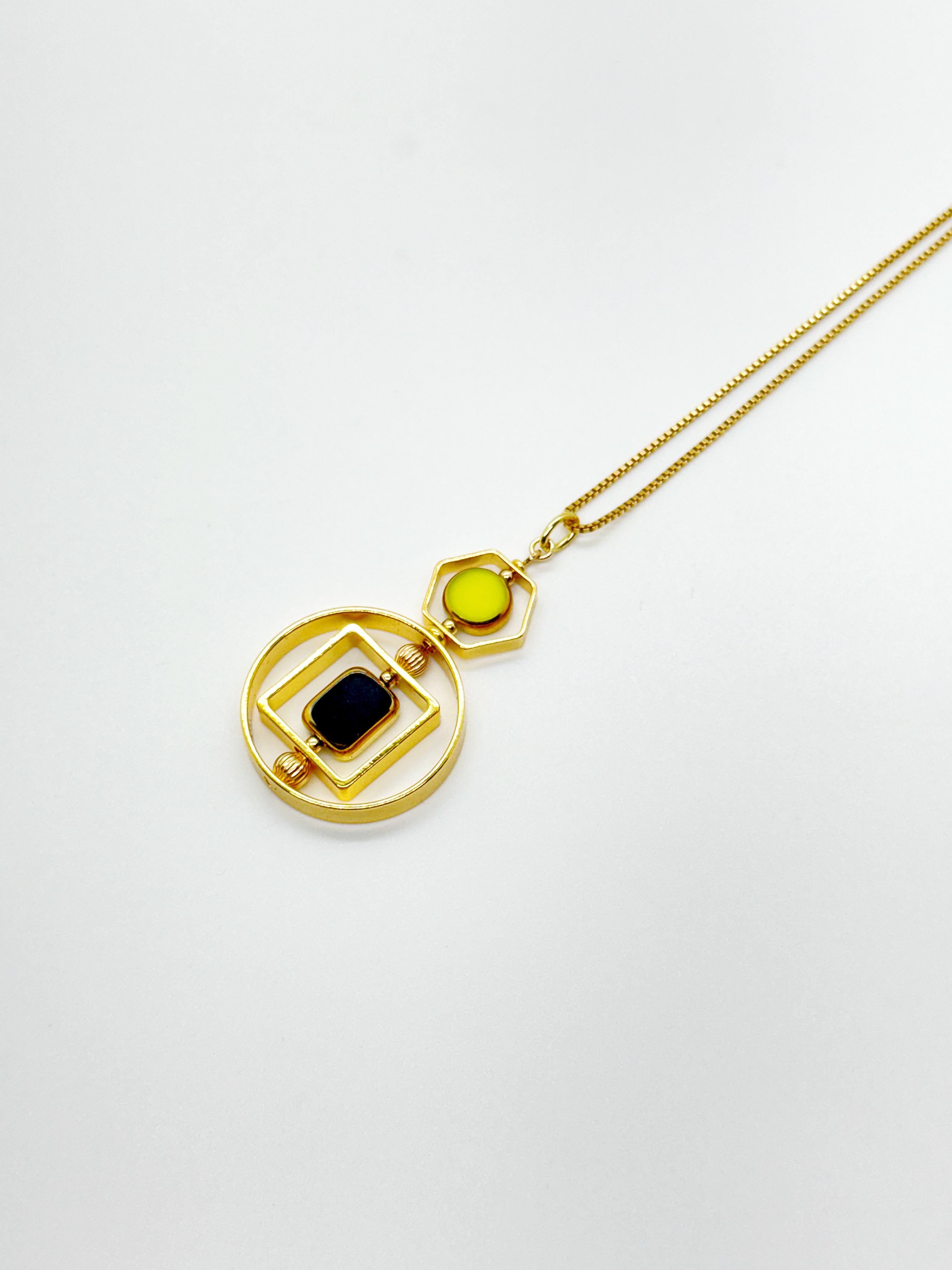 The pendant consist of black and chartreuse vintage German glass beads and finished with a 18 inch gold filled chain. 

The beads are new old stock vintage German glass beads that are framed with 24K gold. The beads were hand pressed during the