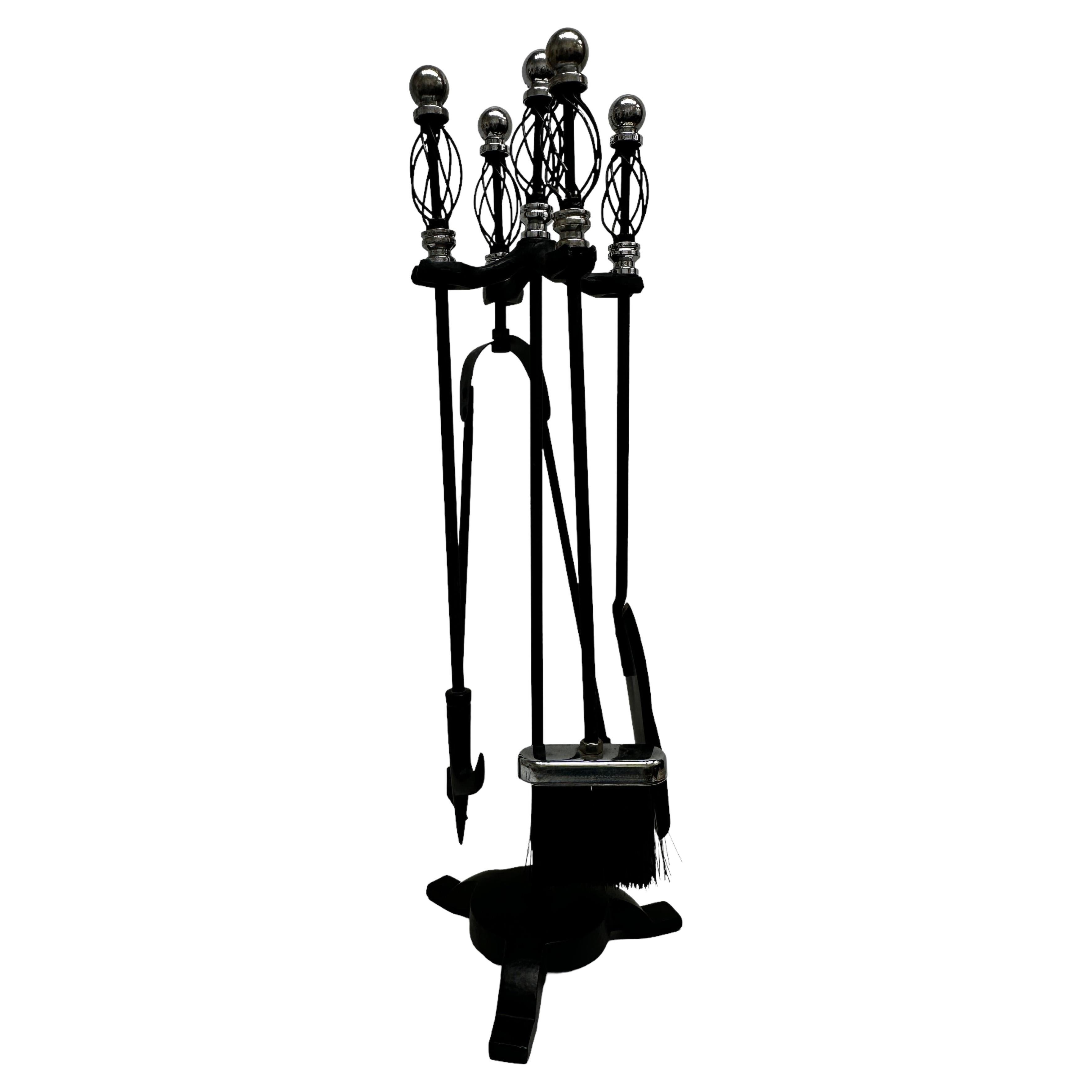A fireplace tool set, fire irons made of black colored metal and chrome or nickel plate handles. Original as found condition (see all the detailed pictures). Some patina to the metal, but this is old-age. Set of 4 tools and the stand. A dent at the