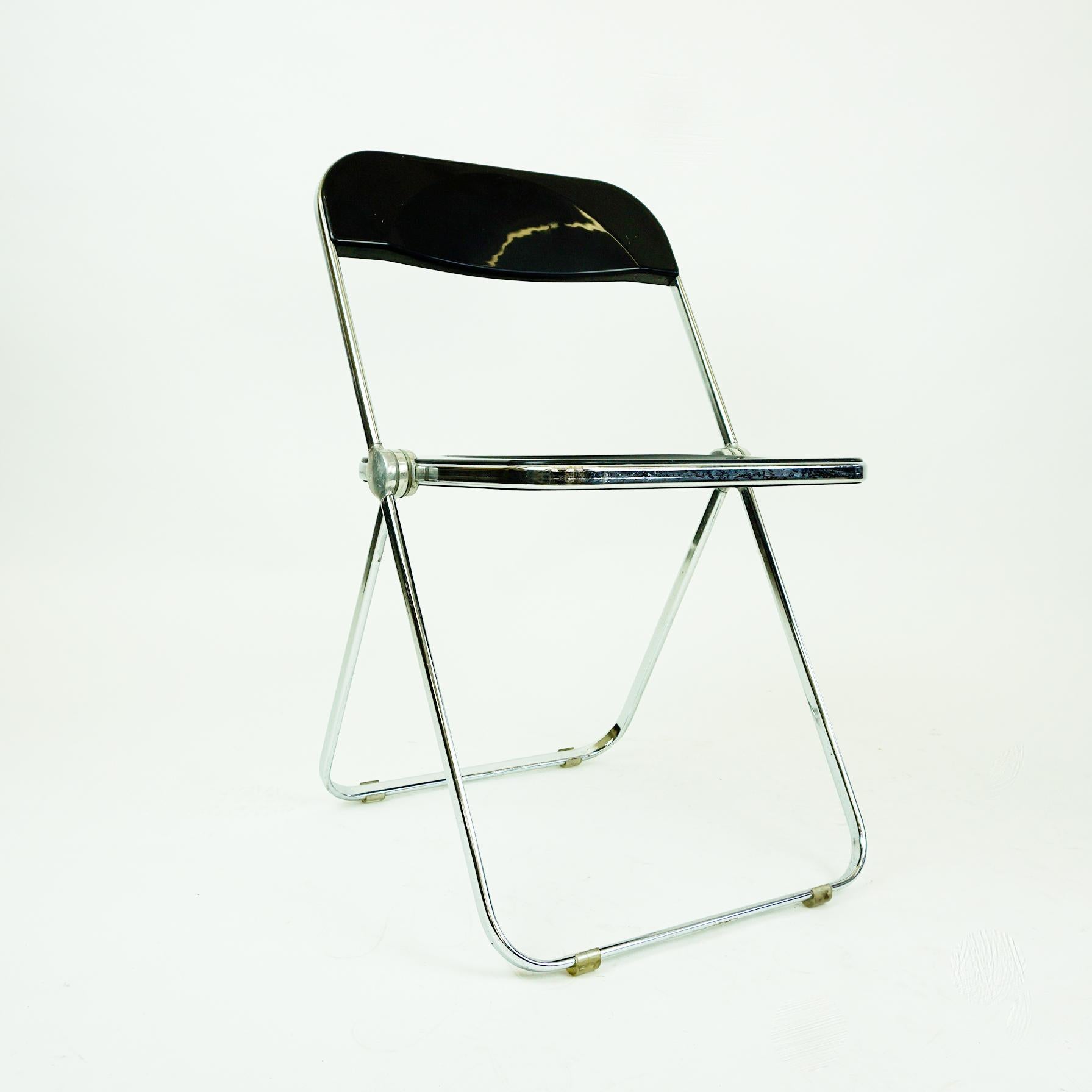 Iconic Italian Mid-Century Modern folding chair in black plastic and chrome, designed by Giancarlo Piretti 1967 for Anonima Castelli, Italy. The Plia folding chair is a real design Classic as it won several prices and is part of the MoMA collection