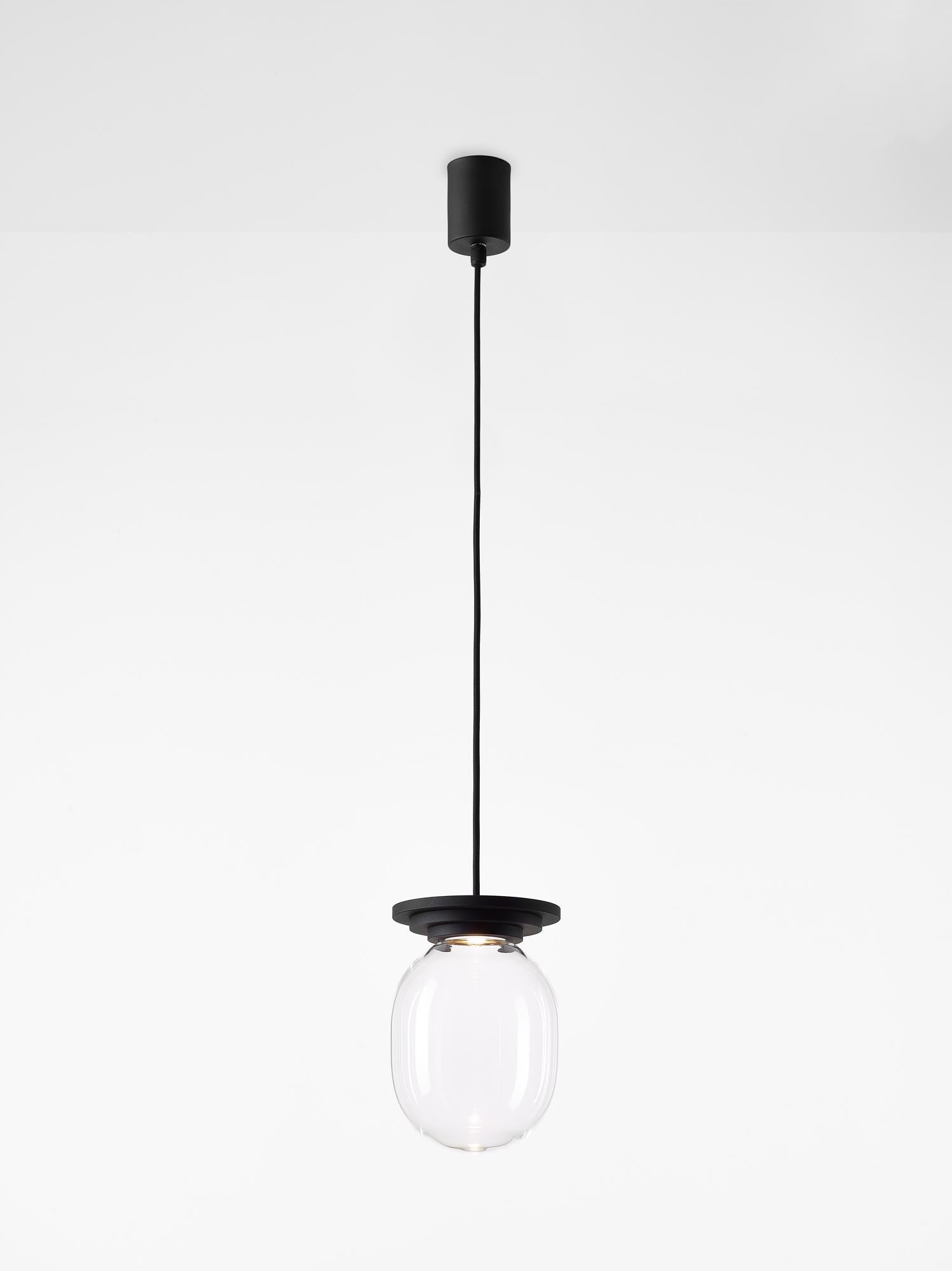 Black and Clear Stratos big capsule pendant light by Dechem Studio
Dimensions: D 20 x H 28 cm
Materials: aluminum, glass.
Also available: different colours available.

Different shapes of capsules and spheres contrast with anodized alloy