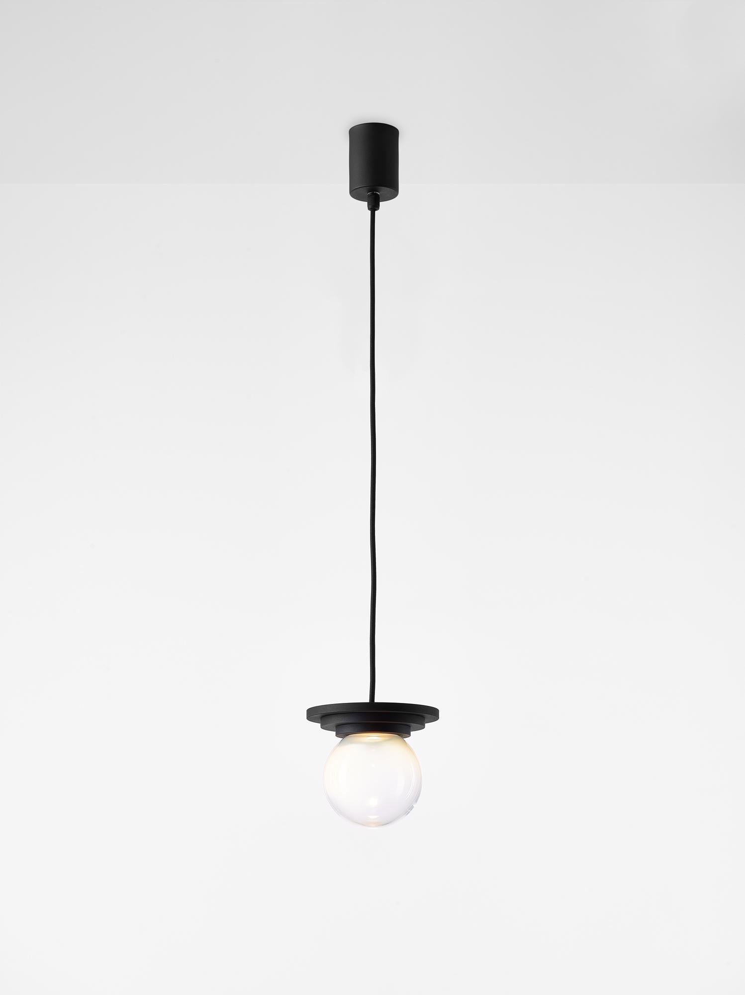 Black and Clear Stratos Mini Ball pendant light by Dechem Studio
Dimensions: D 12 x H 14 cm
Materials: Aluminum, Glass.
Also Available: Different colours available.

Different shapes of capsules and spheres contrast with anodized alloy