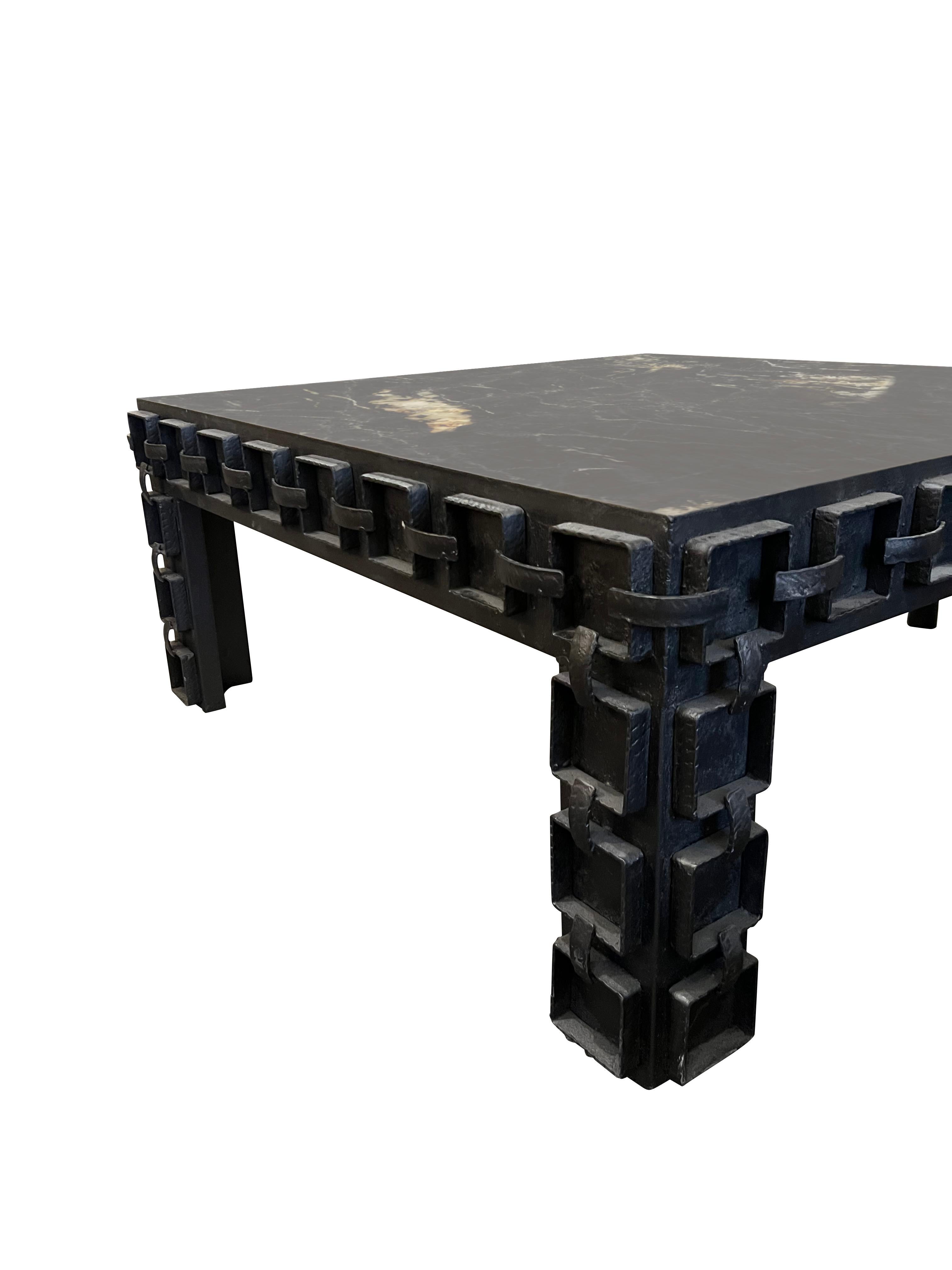 1960's Spanish Brutalist design iron base coffee table.
Base has raised squares with iron strips creating a chain appearance.
New black with cream marble top with polished finish.