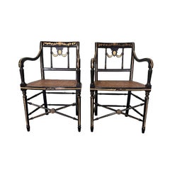 Black and Gilt Empire Style Chairs with Cane Seats, a Pair