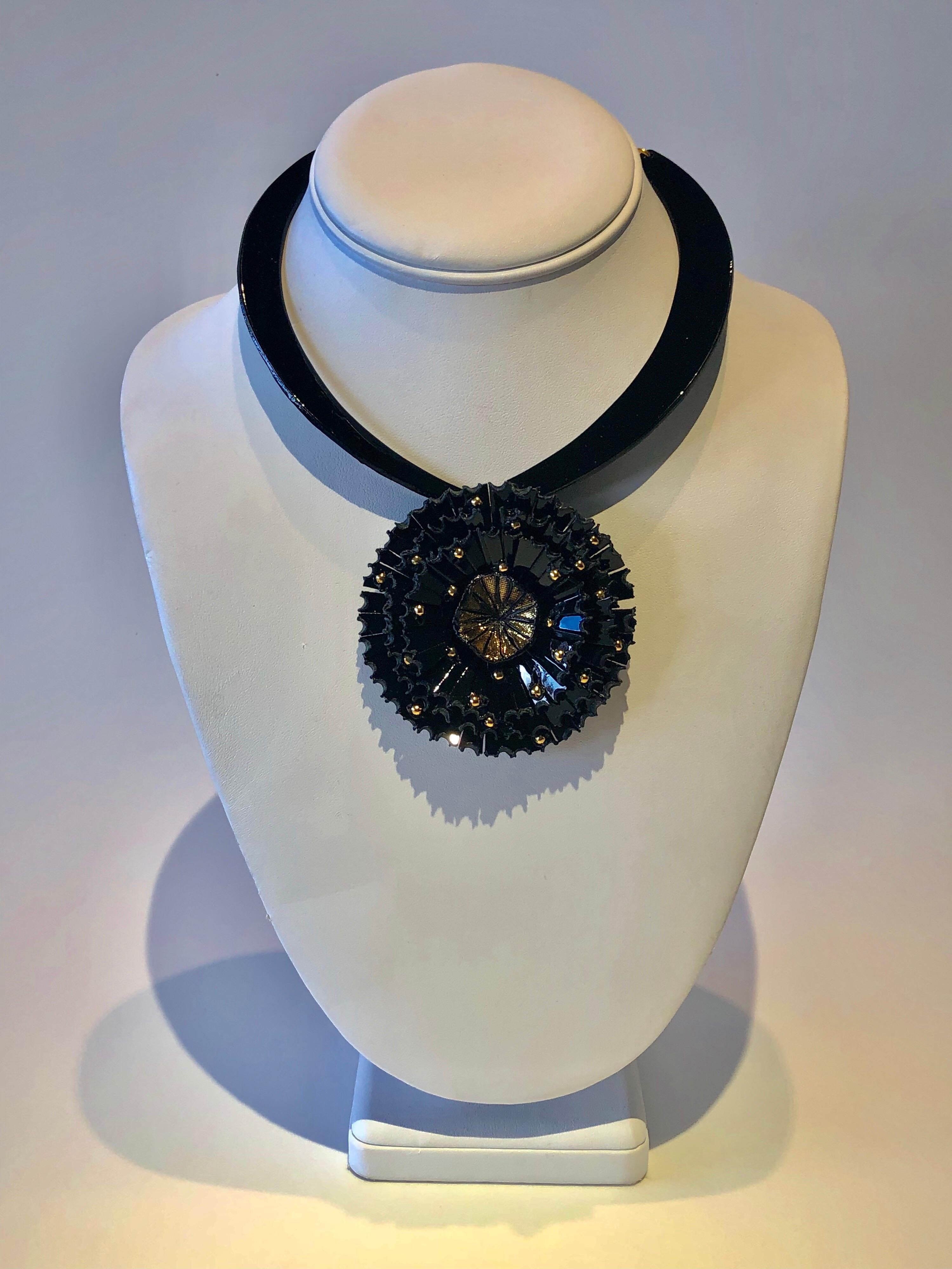 Light and easy to wear, this handmade artisanal contemporary statement necklace was made in Paris by Cilea. The lightweight necklace/collier features a giant architectural flower, comprised out of black enamel and resin. The slowers