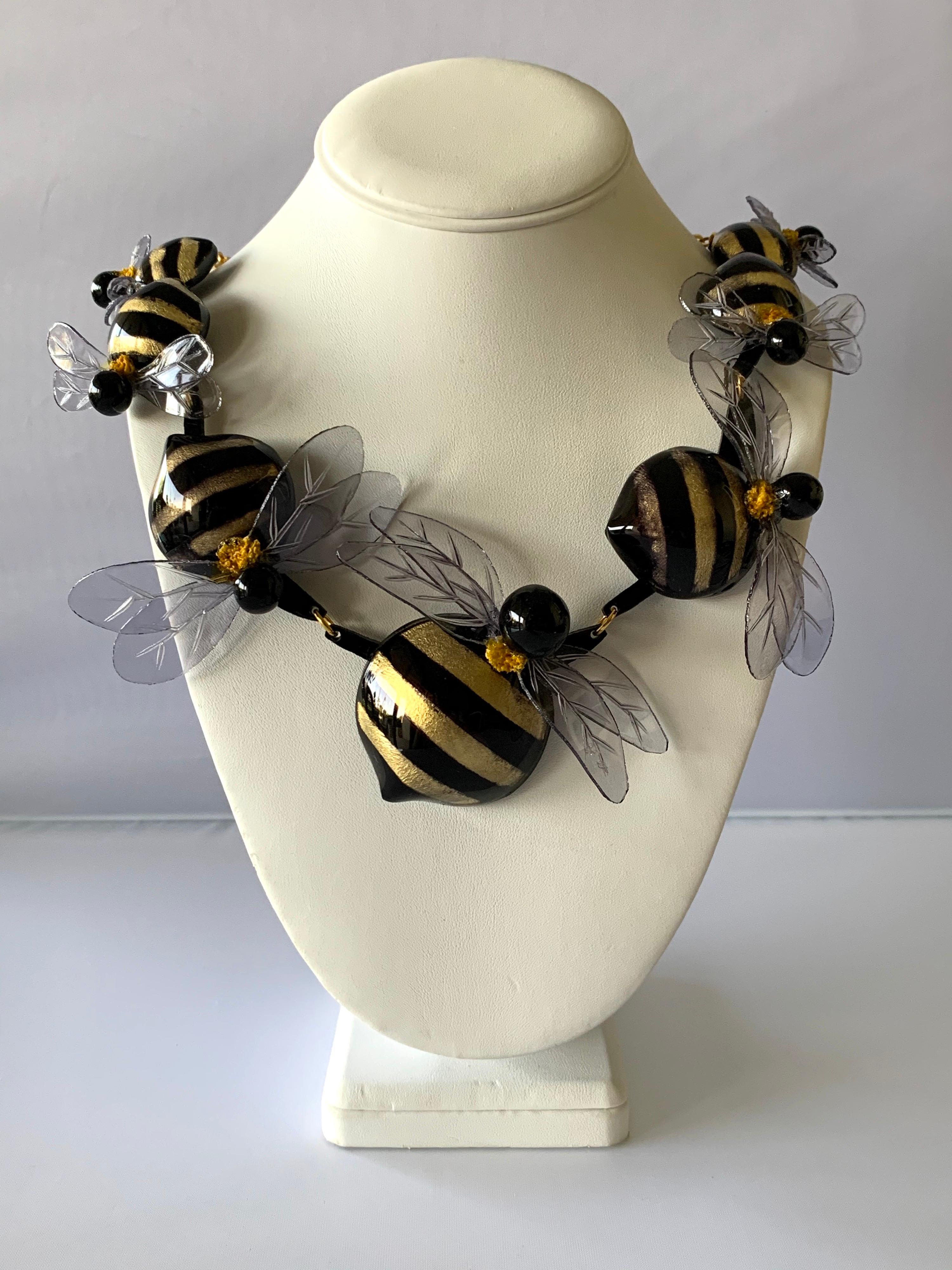 Contemporary designer bumblebee statement necklace by Cilea Paris - the bold necklace is comprised out of a row of highly adorned enameline (resin and enamel) gold and black bumblebees. The bumblebees are in three sizes and they all feature