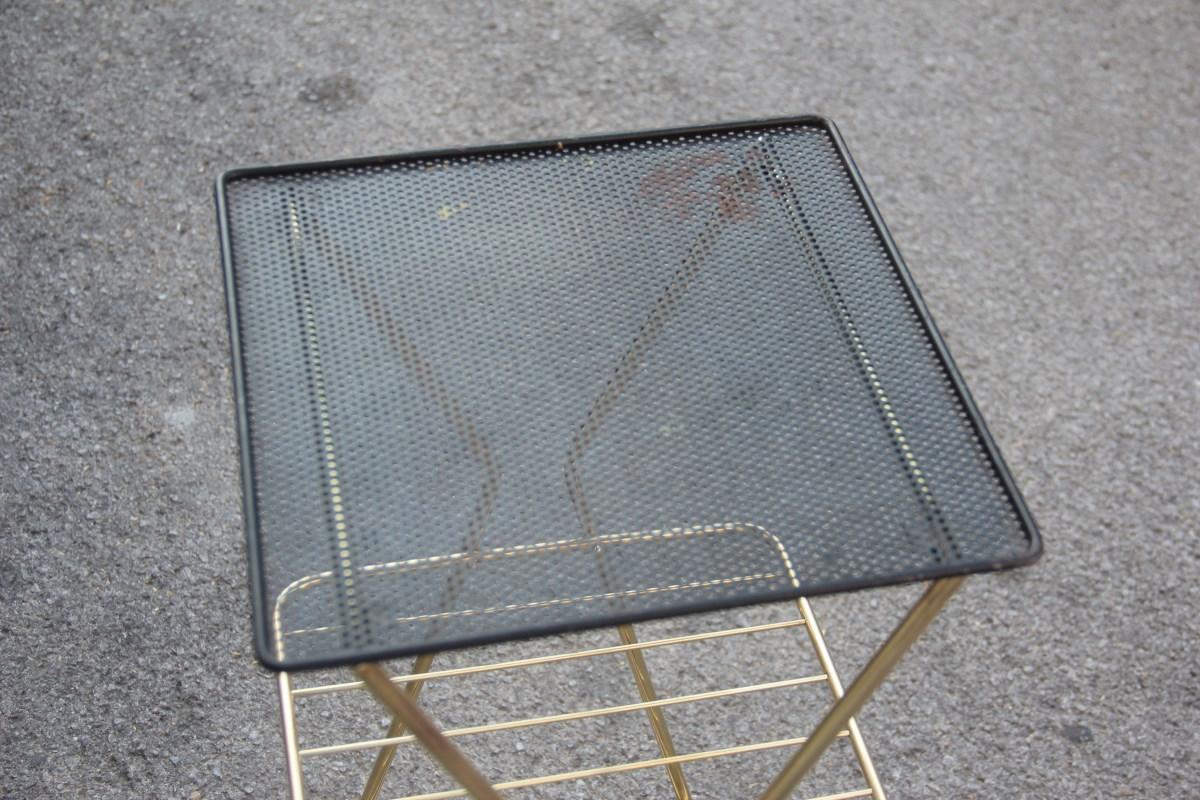 Black and gold brass midcentury French Selve Gueridon style Mathieu Matégot.
Black perforated metal, brass structure with brass rod shelves, very Minimalist and rational design.