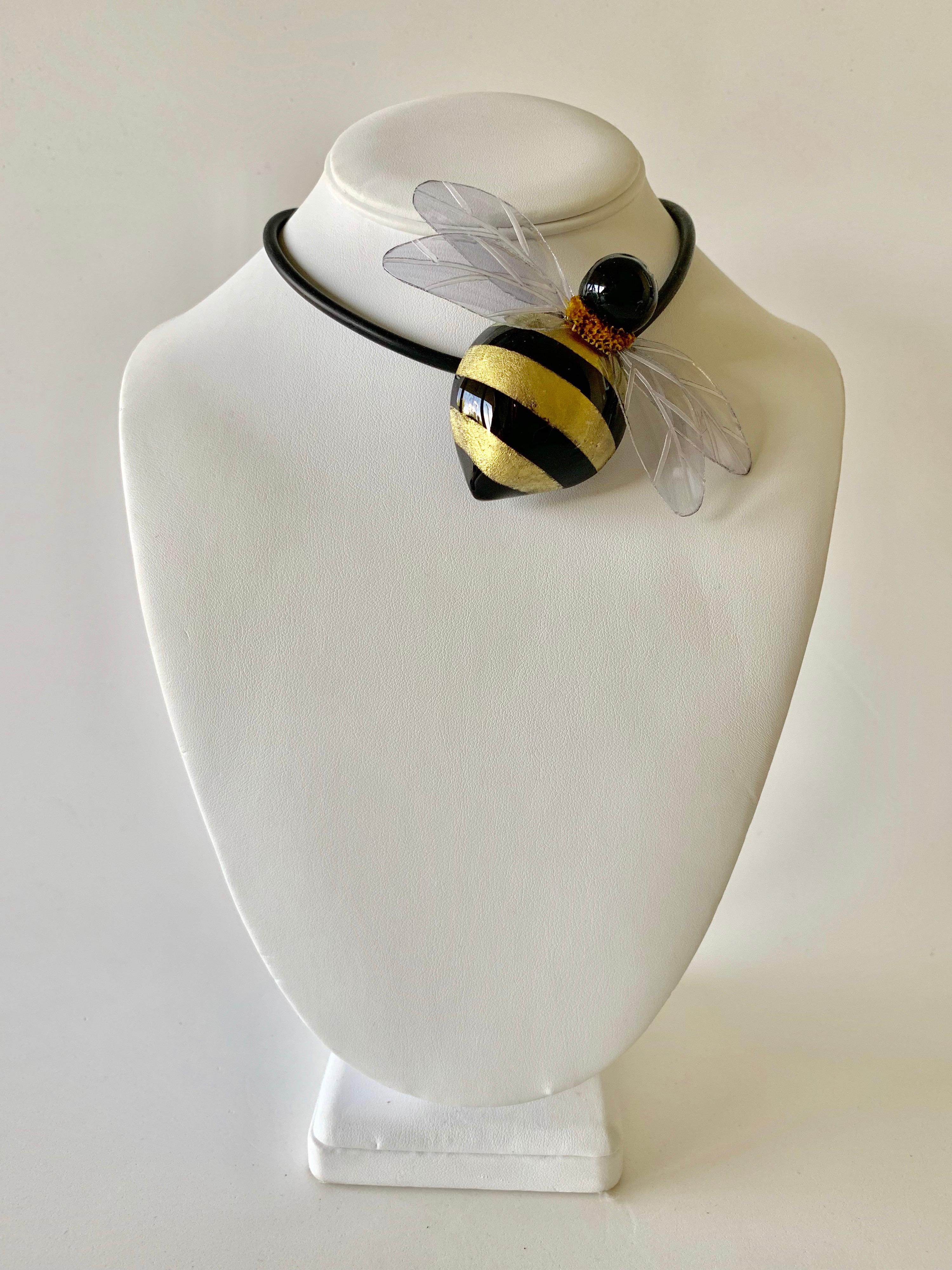 Unique handcrafted contemporary artisanal brooch - statement necklace made in Paris France by Cilea Paris - lightweight, featuring a large black and gold bumblebee. The bumblebee is comprised out of resin and enamel and has large carved clear