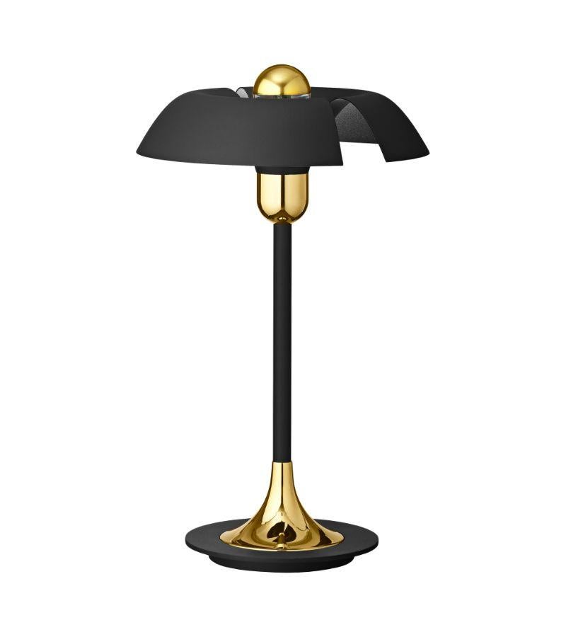 Black and gold contemporary table lamp 
Dimensions: Diameter 30 x Height 48 cm 
Materials: Aluminum with Powder-Coated. Brass plated details, Porcelain socket, Plastic switch, and Black textile cord. 
Details: For all lamps, the light source is