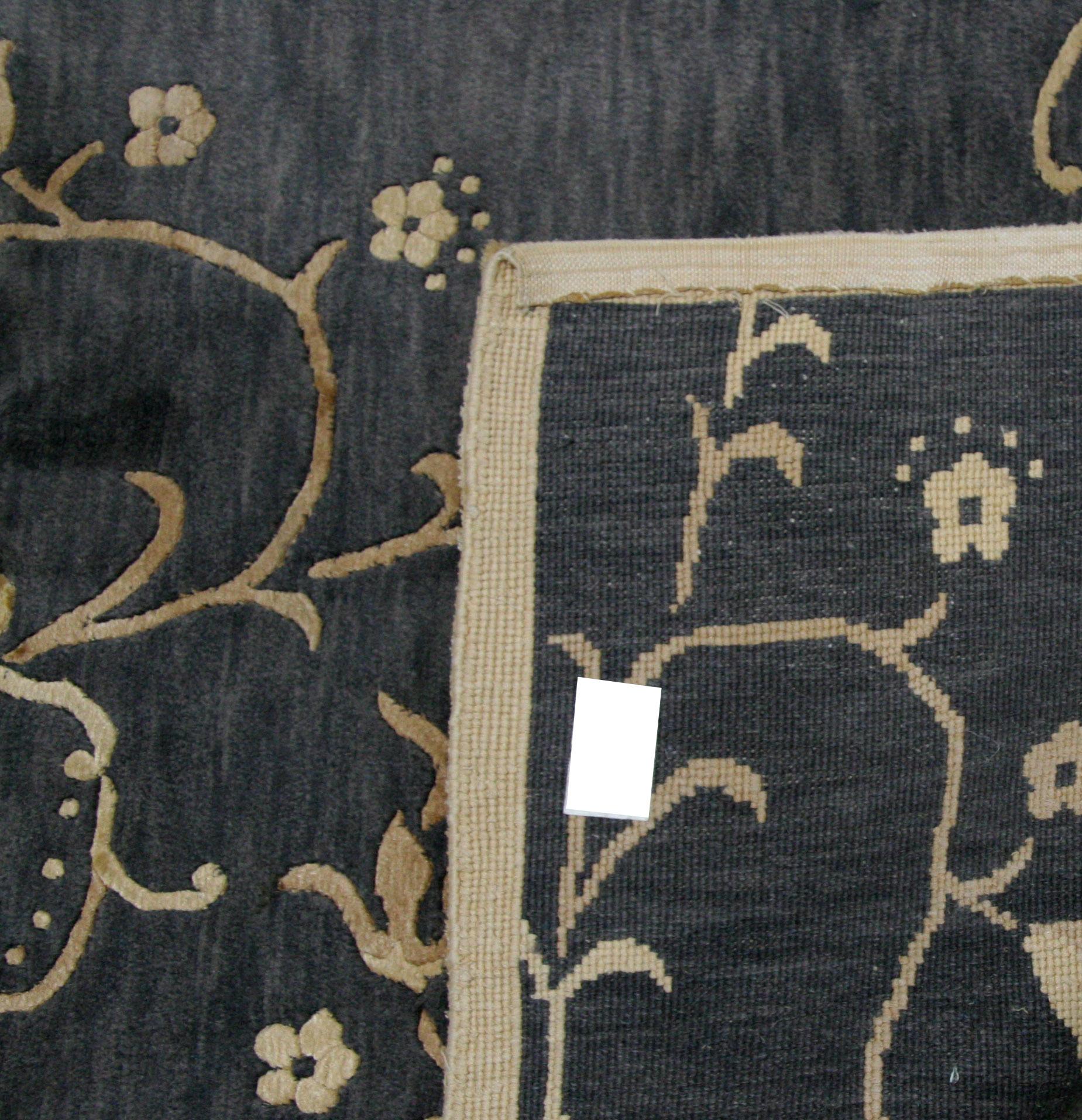 A simple floral scroll creates a simply elegant rug when it's gold and black. The hand knotted wool and silk combination means a smooth-to-the-touch feel that is also durable. Ideal for creating an intimate space-within-a-space.

Hand knotted in