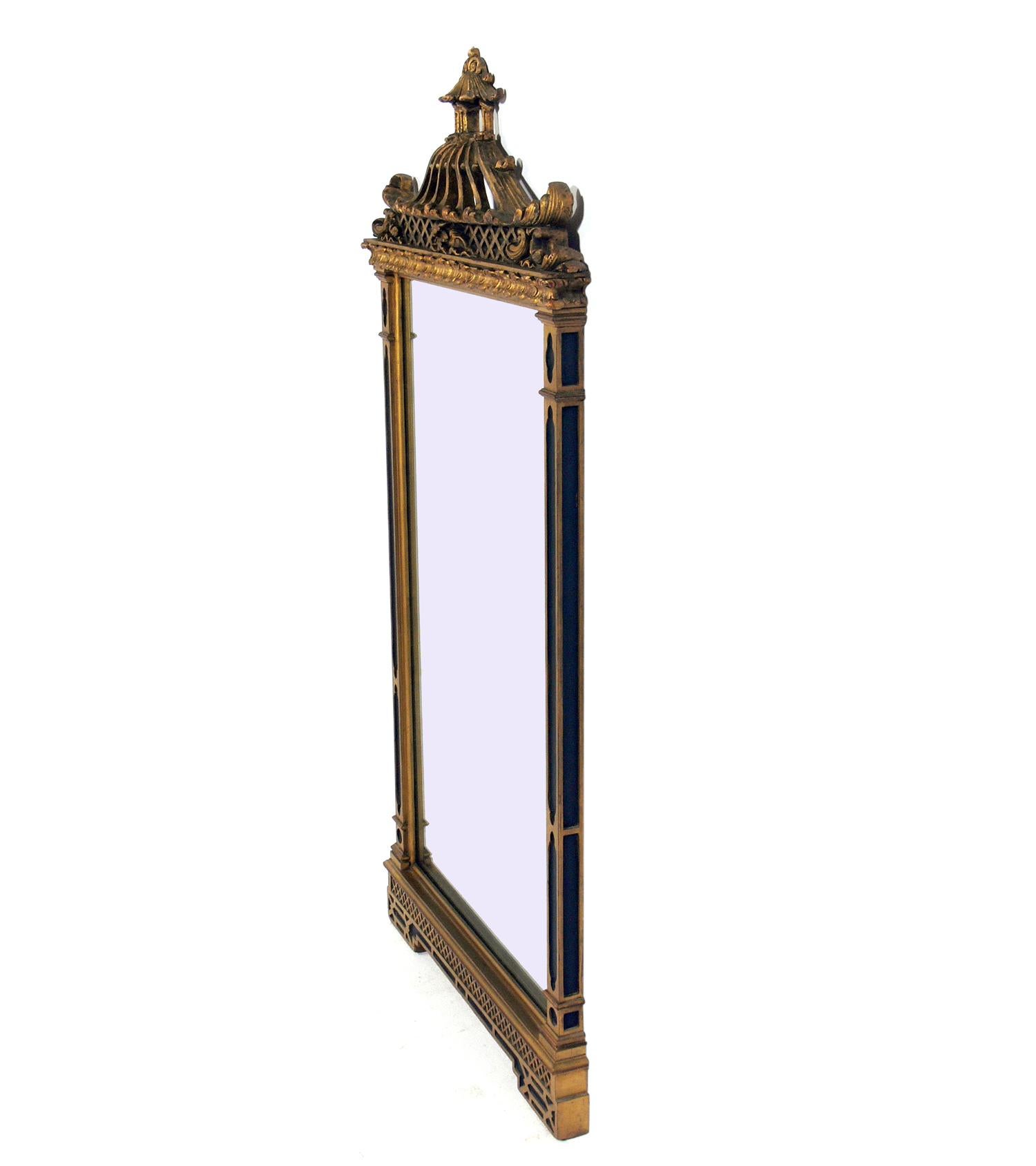 Black and gold gilt chinoiserie mirror, circa 1950s. Retains it's warm original patina to the giltwood frame and the original mirrored glass.