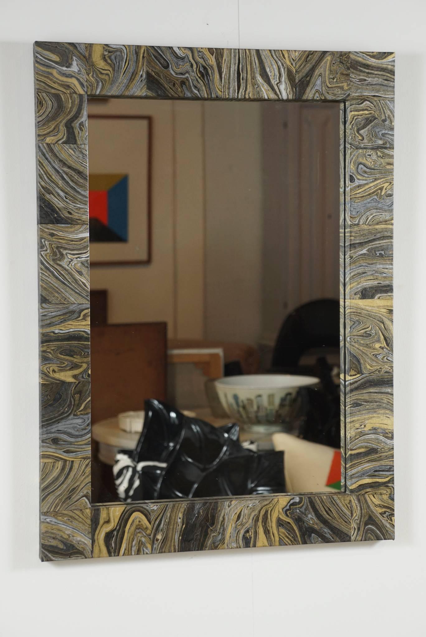 Here is a beautiful mirror that has been decoupaged with a black and gold marbleized paper. The paper has been cut to have a blocked random pattern. The frame is sealed with a brush on satin clear coat.
The surround frame measures 2.5 inches wide