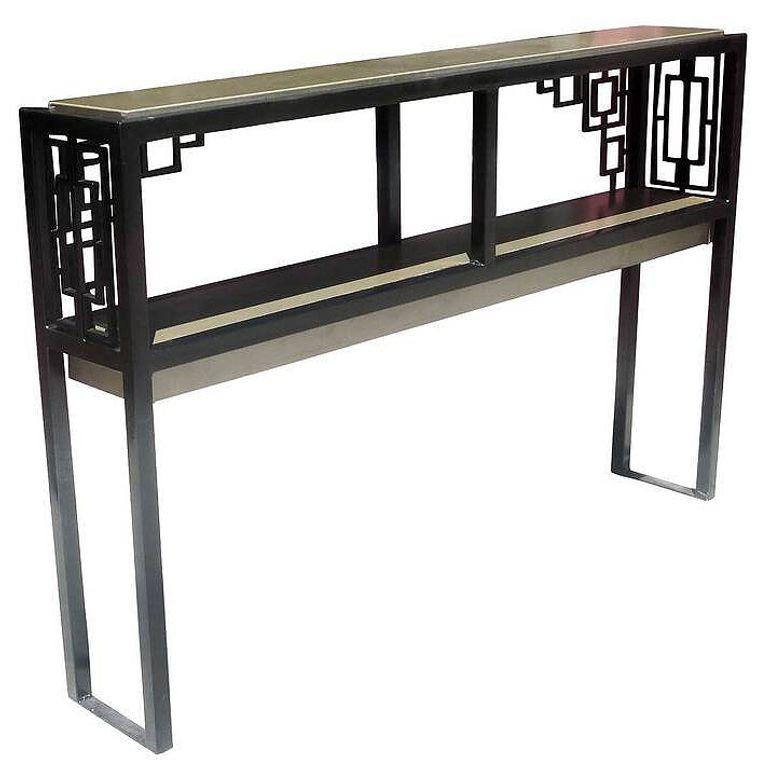 Geometric Art Deco Style black and gold painted tubular steel console table with ornamental sides and back, with a two-tier design. This Console Table is reminiscent of the 