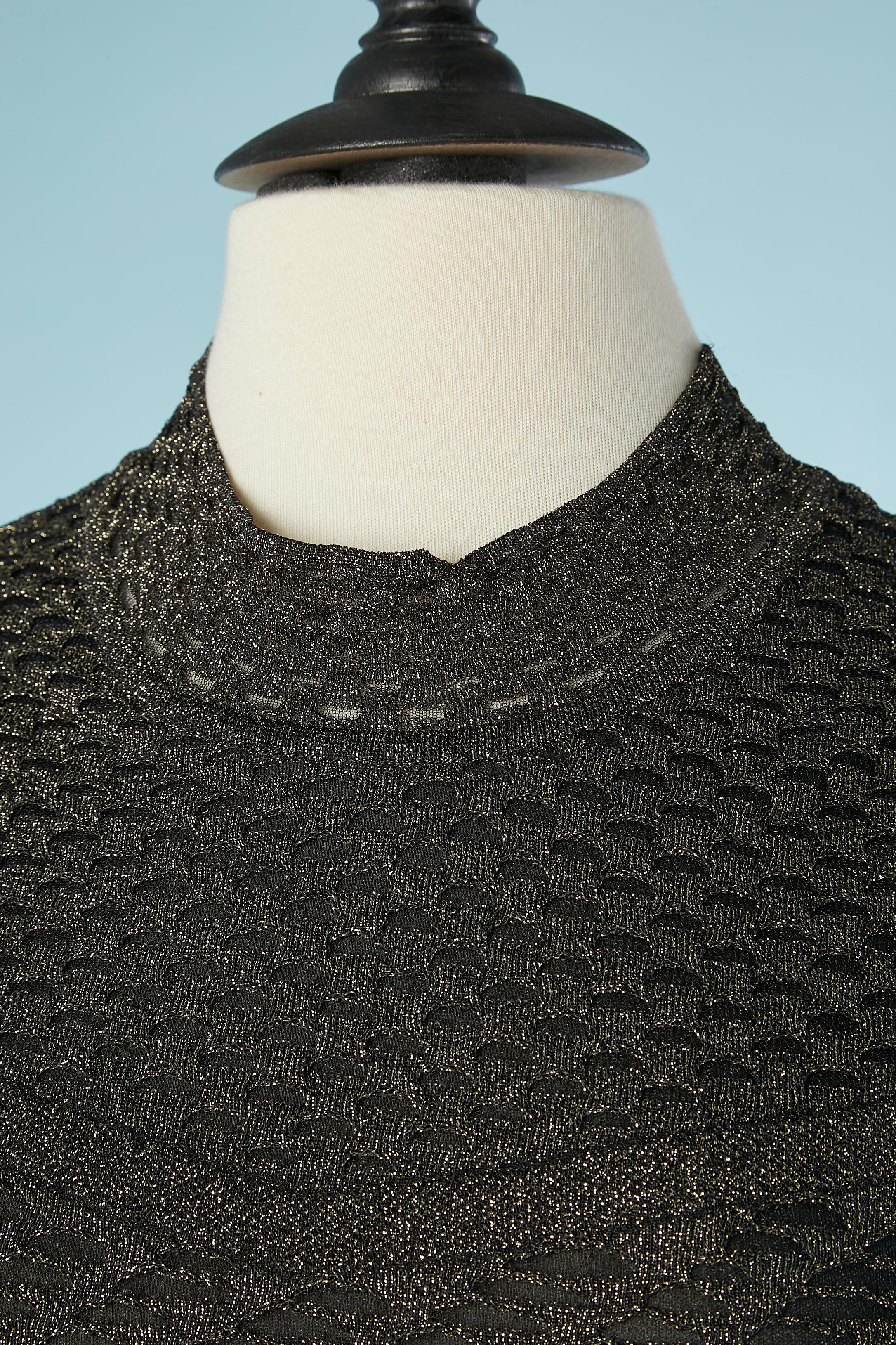 Black and gold sleeveless knit top . Main fabric composition: 89% polyamide, 11% polyester. Lining ( only in the front, from the nackline until the waist) : 100% polyester. 
See-through on the back and bottom 
SIZE 38 ( It) 34 (Fr) XS 