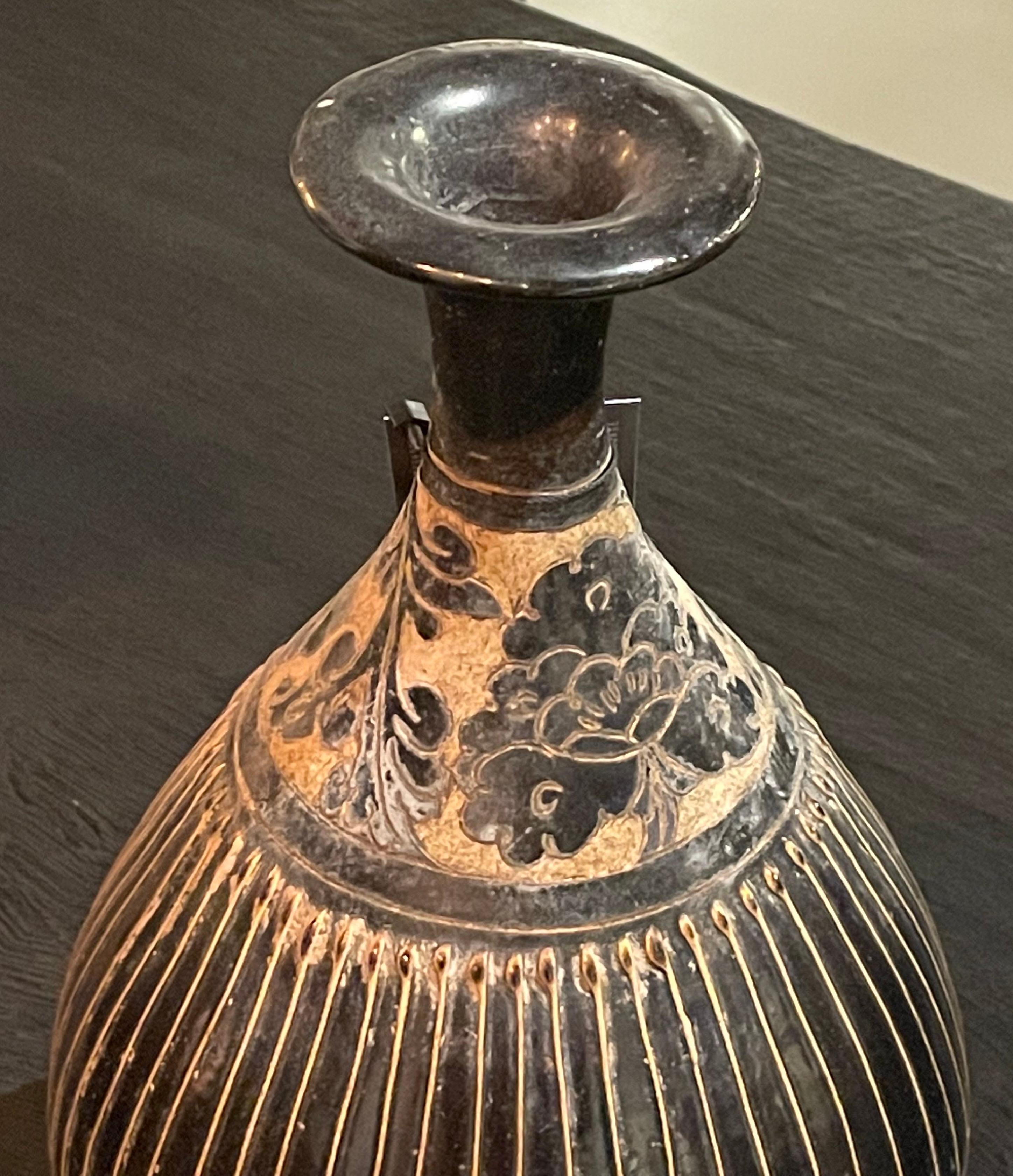 Contemporary Chinese black and gold stripe vase with 
decorative design on top of tulip shaped vase.
Two available and sold individually.
Arriving TBD.