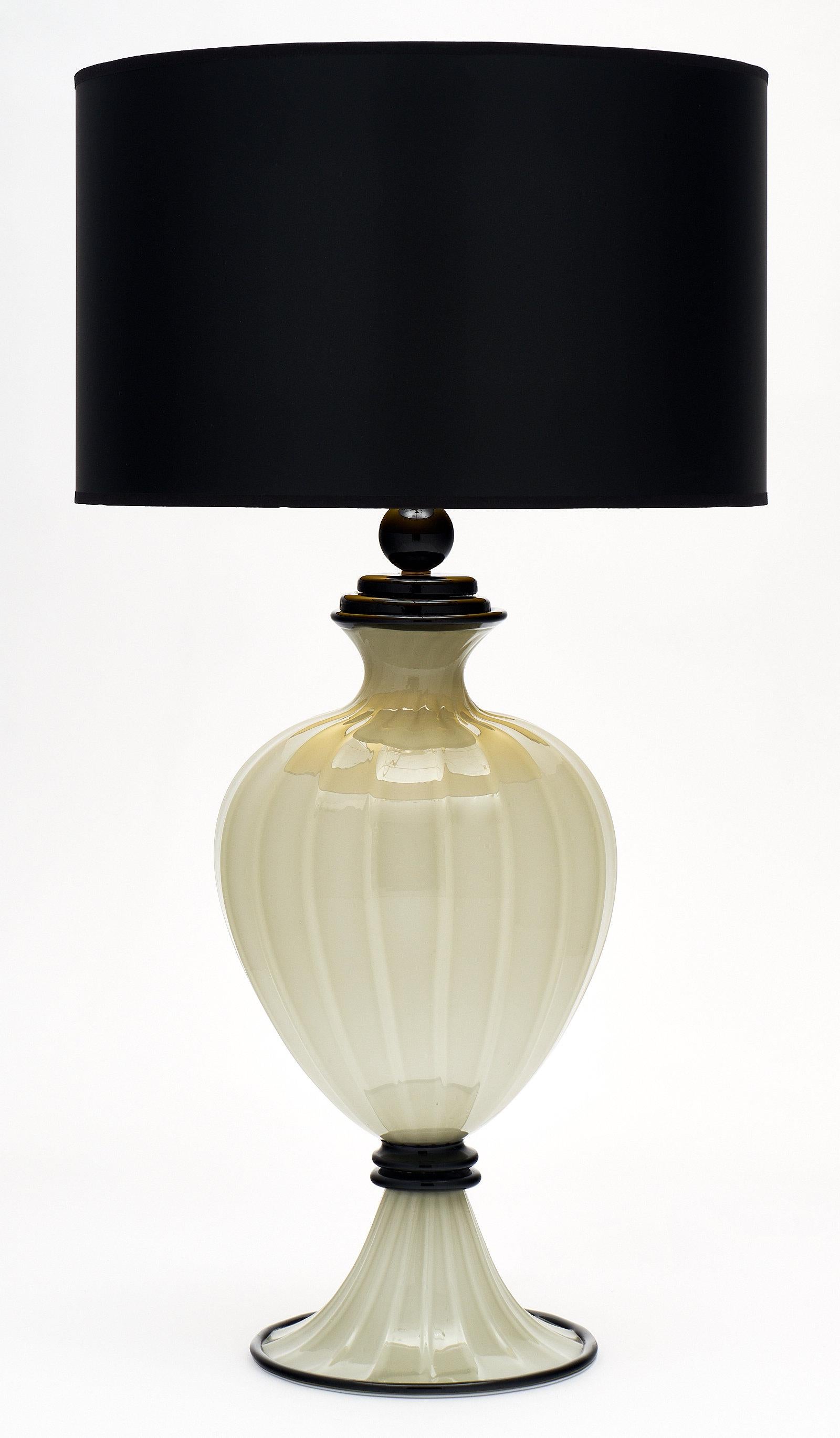 A unique pair of gray and black Murano glass lamps. This hand-blown pair combines gray glass with black details. They have been newly wired to fit US standards.