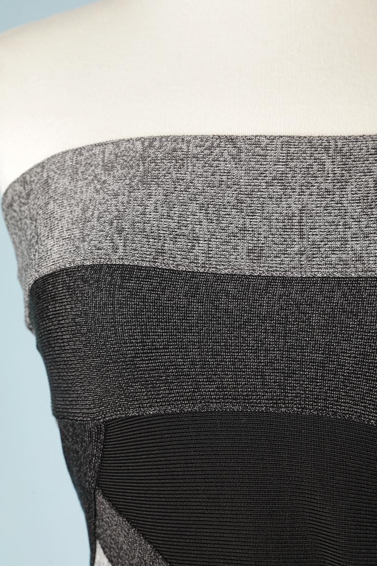 Robe de cocktail en tricot extensible noir et gris avec fermeture éclair au milieu du dos. Bande de silicone adhérente à l'intérieur du buste. 
TAILLE S