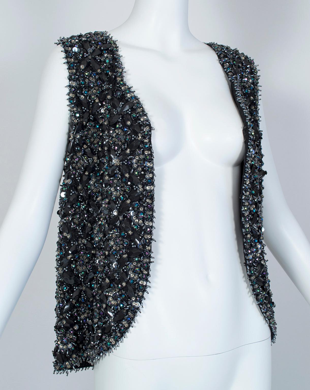 Weighing nearly three pounds, every square inch of this remarkable vest is covered--in some areas up to a half an inch high--in enormous faceted beads, sequins or bugle beads. And though the vest is predominantly black, the aurora borealis finish on