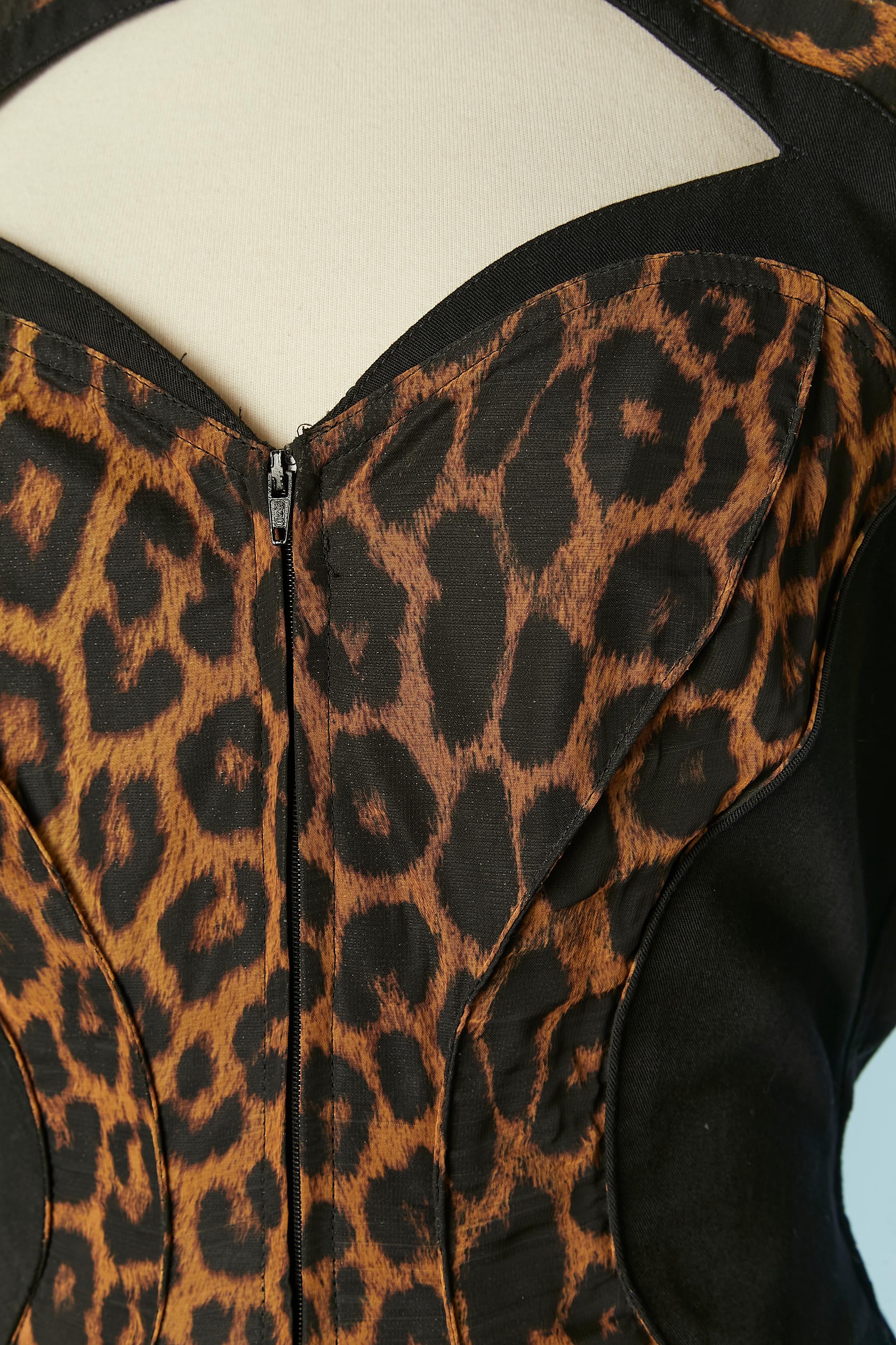 Black and leopard print jumpsuit with gold jewellery embellishement. 
No fabric tag composition but the leopard fabric is probably polyester and the black fabric probably rayon. Cut-work. Large shoulder-pad. Pockets on both side. Top-stitched cuffs.