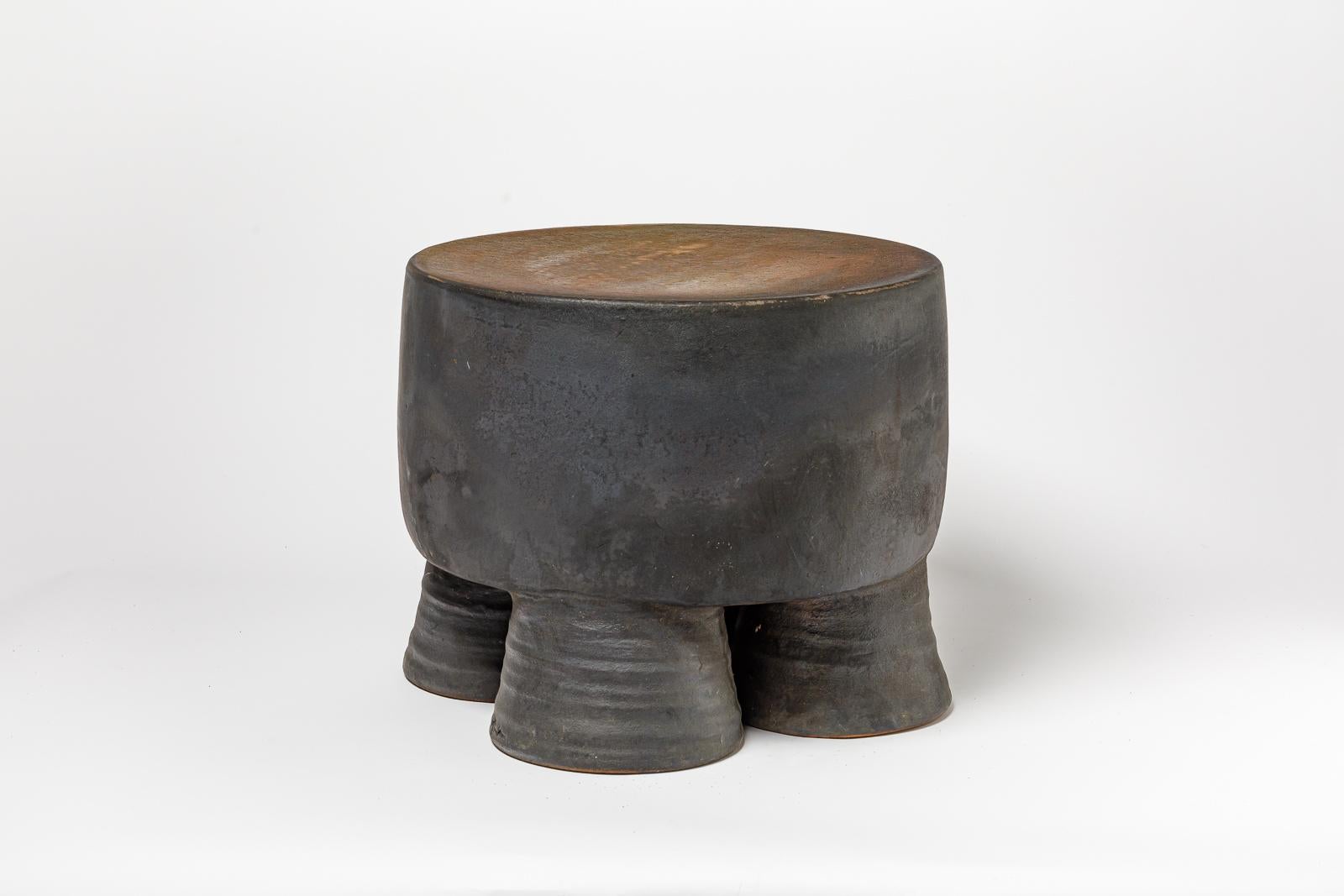 Black and ocher glazed ceramic stool or coffee table by Mia Jensen. 
Artist signature under the base. 2023.
H : 14.3’ x 16.5’ inches.
