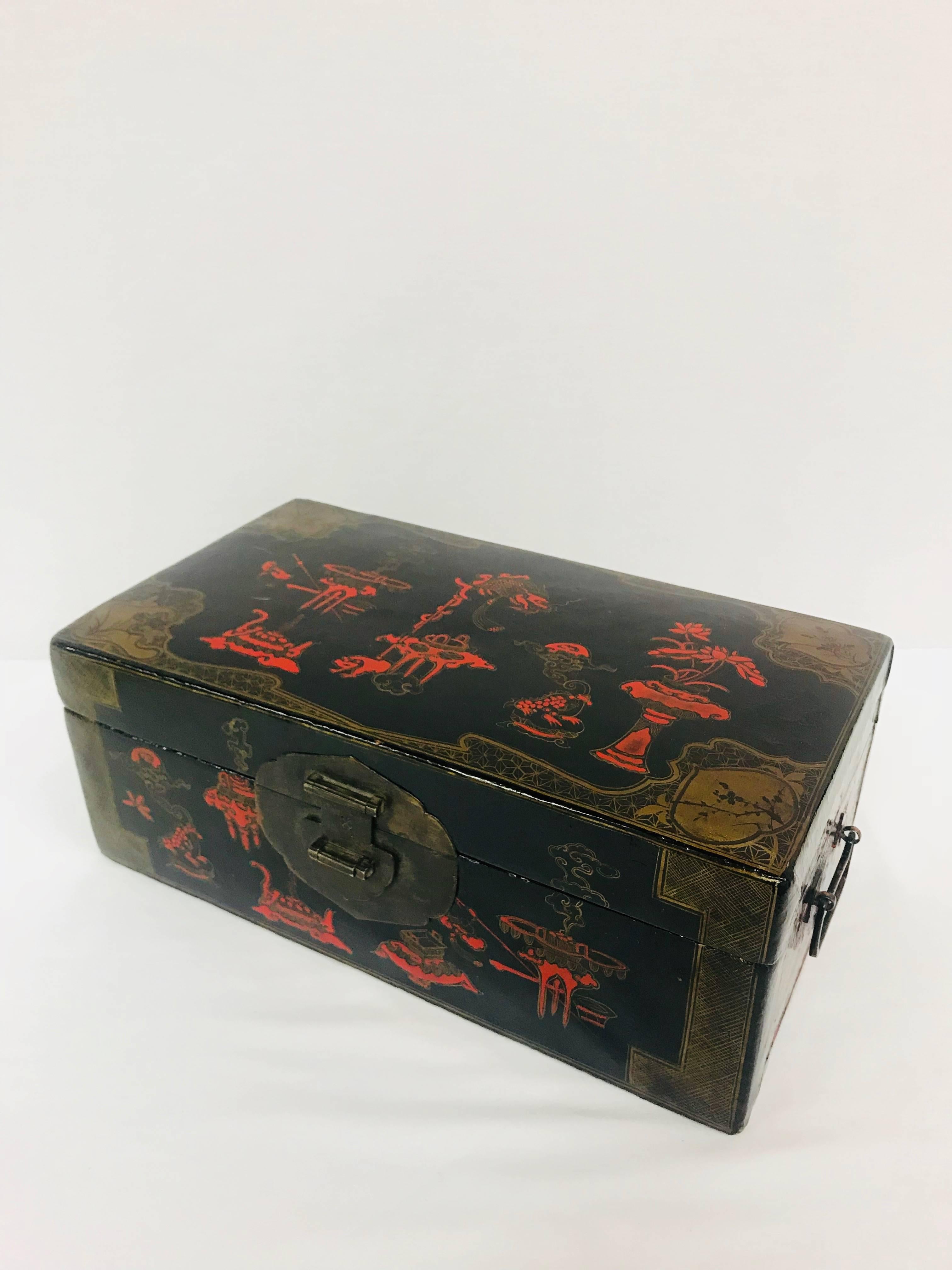 A late 19th century Chinese lacquered box decorated with scarlet-red and gilt Chinoiserie motifs. Stunning brass hardware will keep your treasures tidy.
Box interior dimensions: 13.25” L x 6.75” W x 4” H.