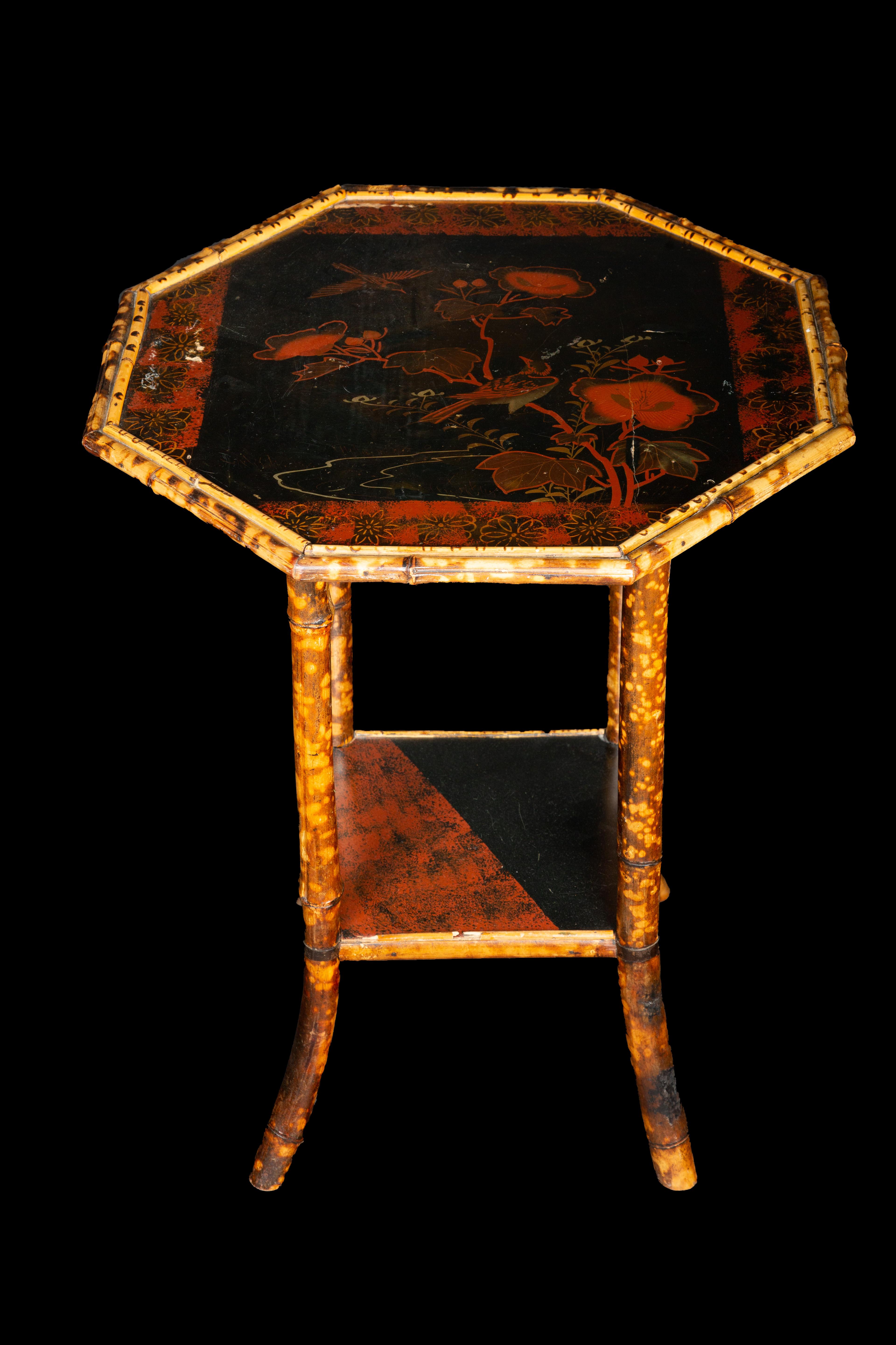 Asian inspired early 20th Century bamboo black and red lacquered side table with painted top of hibiscus flowers and birds:

Measures: 22.5