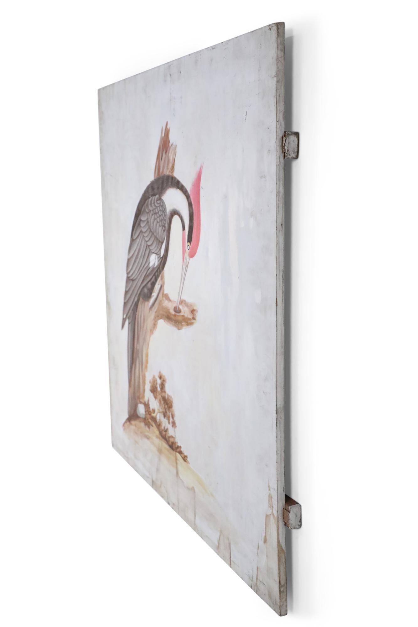 Vintage (20th century) Audubon-style painting of a black and red pileated woodpecker seated on a large stump against a clouded white background, painted on a rustic unfinished plank board.
     