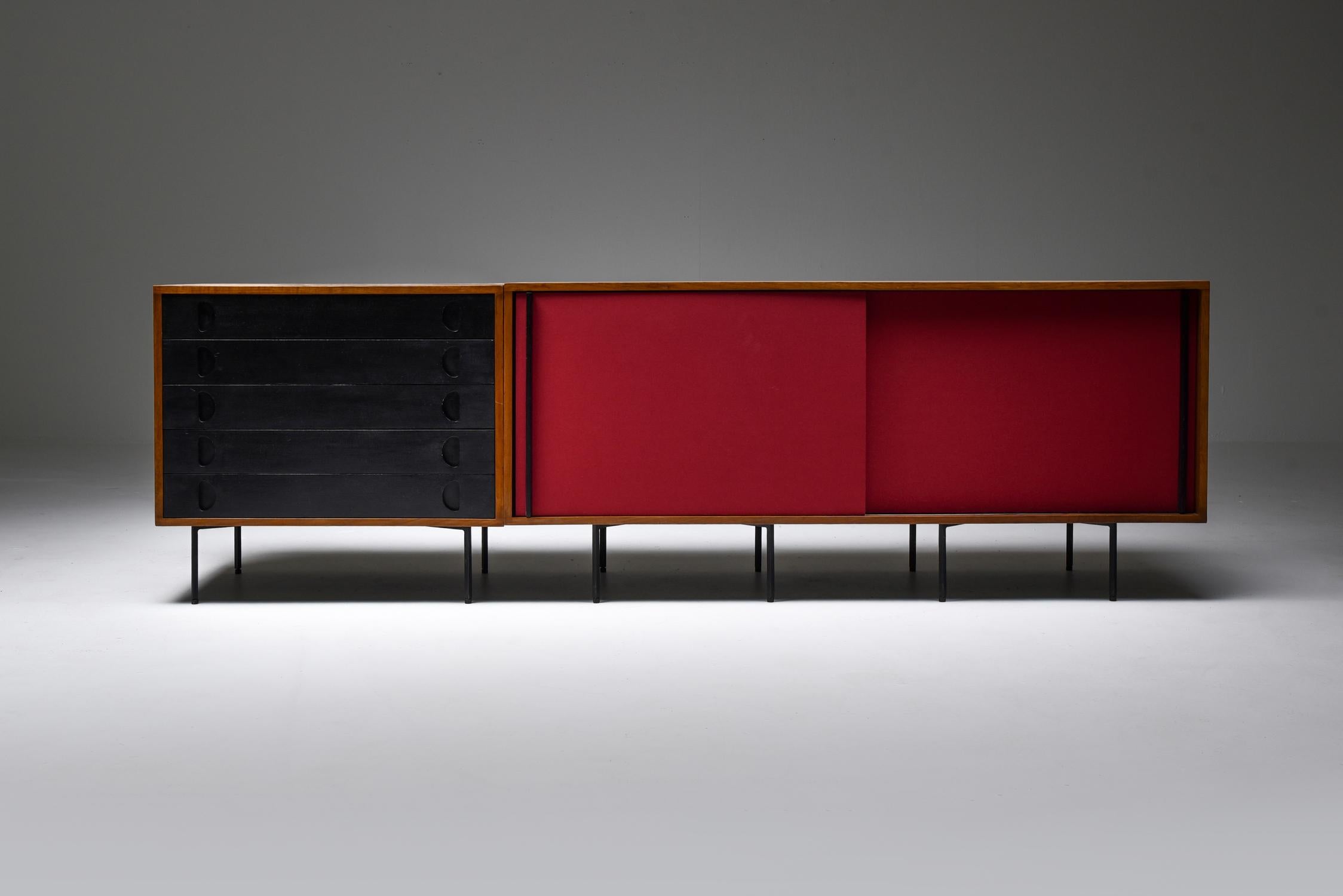 Sideboard with drawers and sliding doors, in teak on metal legs, Franco Campo and Carlo Graffi, Italy, 1950s.

Credenza on pin legs consiting of two units; one with five black lacquer drawers and one with two burgundy red fabric sliding doors by