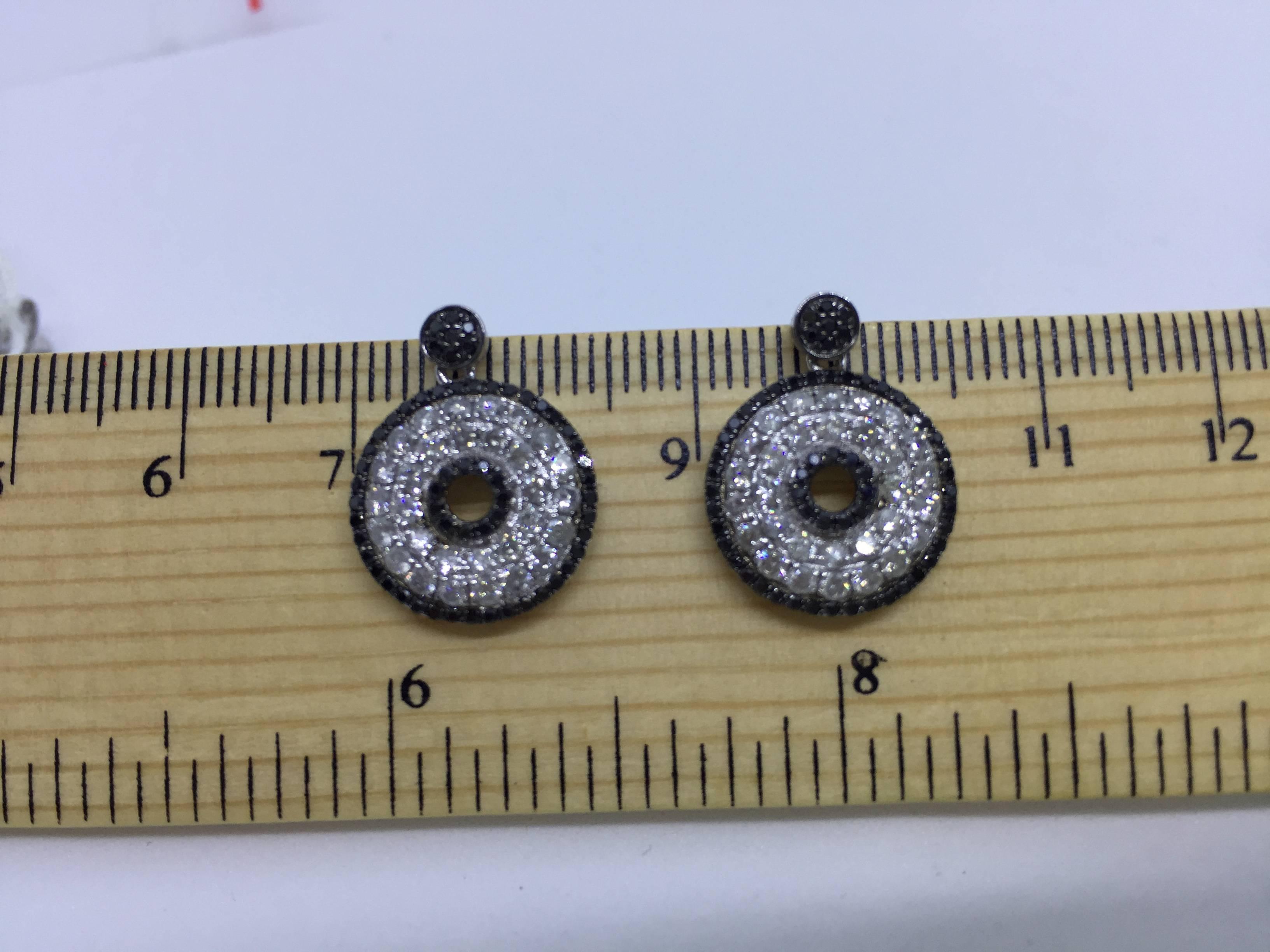 A PAIR OF BLACK AND WHITE DIAMOND EARRINGS by Emily Sam Collection

116 Black Round Diamonds totalling 0.44 Carat
60 Round Brilliant Diamonds totalling 1.20 Carat
18 Carat White Gold
Size 15mm or 1.5cm with the overall drop being 18mm 
by Emily Sam