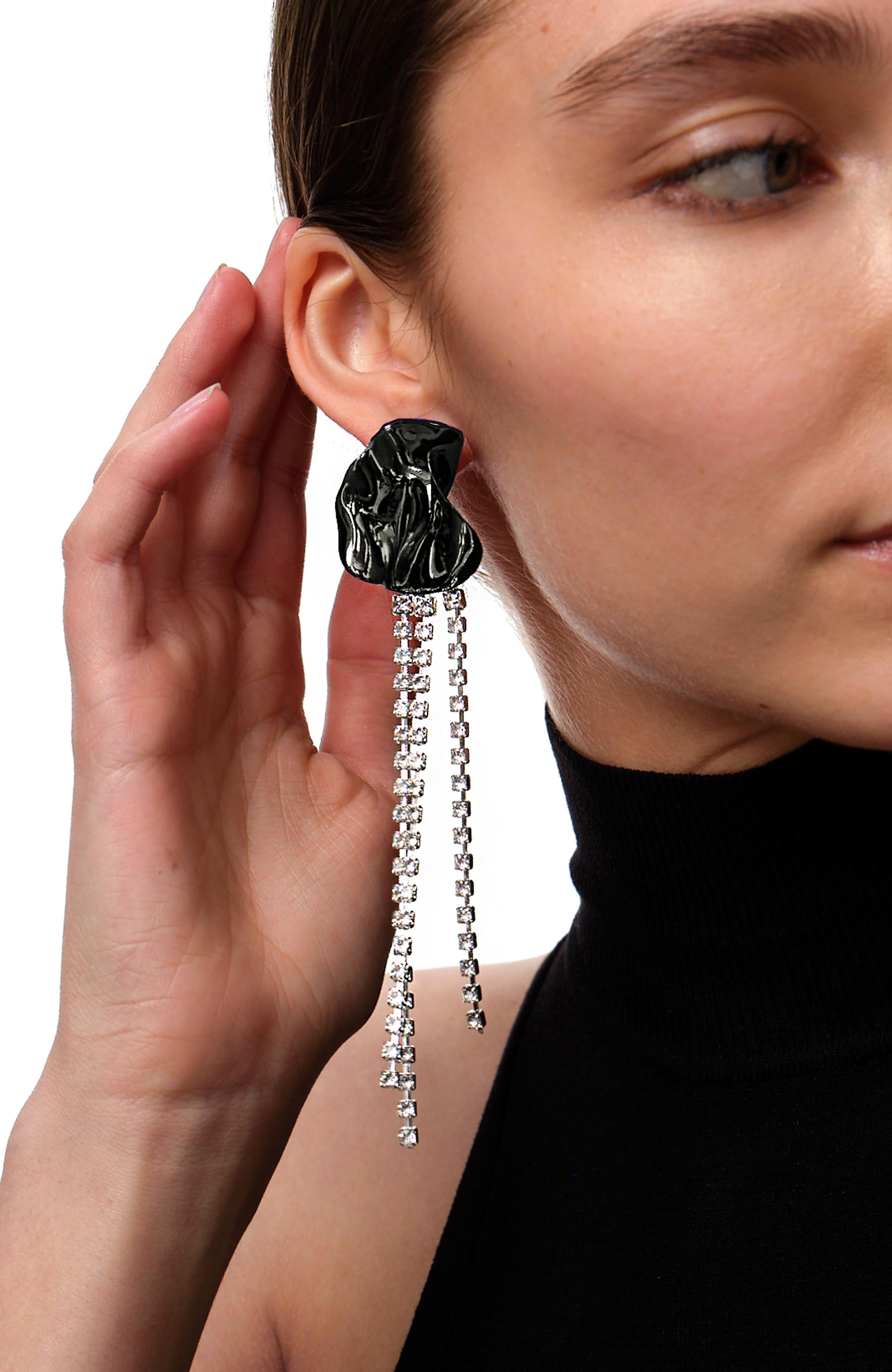 The Georgia crystal-embellished earrings from Sterling King feature a sculptural shape embellished with cascading clear crystals. Inspired by the works of Georgia O'Keeffe, these floral-inspired earrings are finished with metallic black ceramic