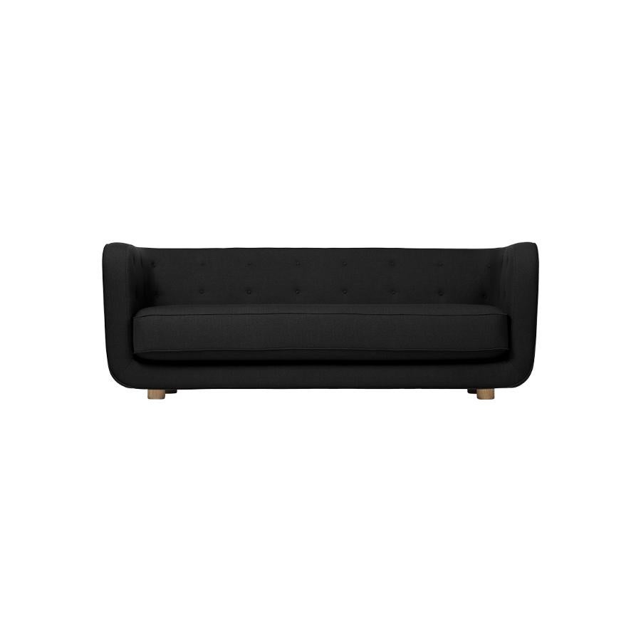Black and smoked oak raf simons vidar 3 vilhelm sofa by Lassen.
Dimensions: W 217 x D 88 x H 80 cm 
Materials: Textile, oak.

Vilhelm is a beautiful padded three-seater sofa designed by Flemming Lassen in 1935. A sofa must be able to function in