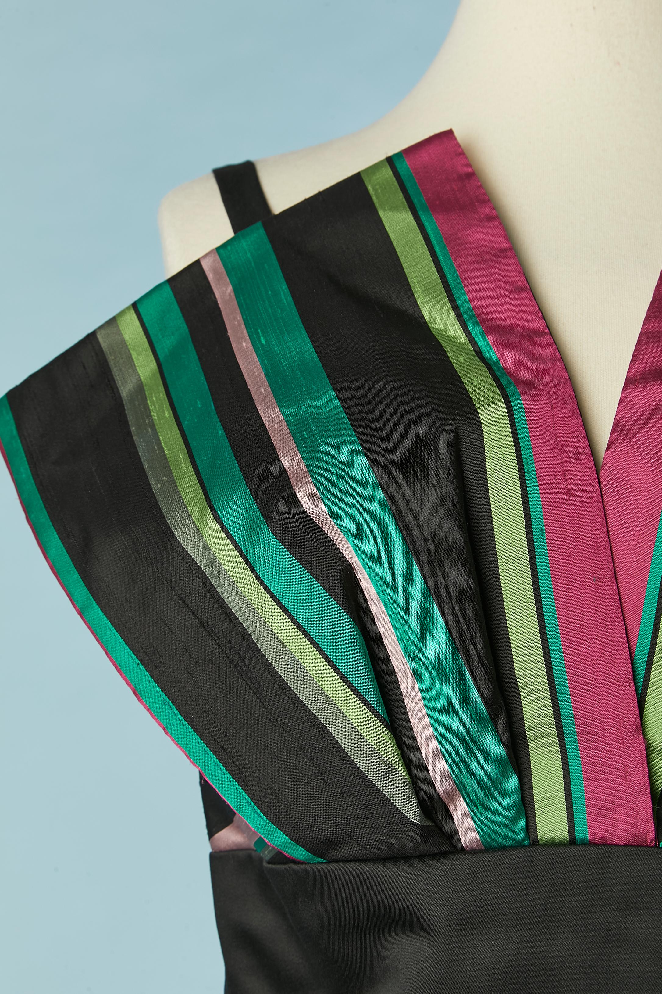 Black and striped evening dress. No fabric tag composition but the striped fabric is probably silk and the black fabric is probably rayon. And acetate lining. Boned bustier. Zip and hook&eye closure in the middle front. 
Size L 