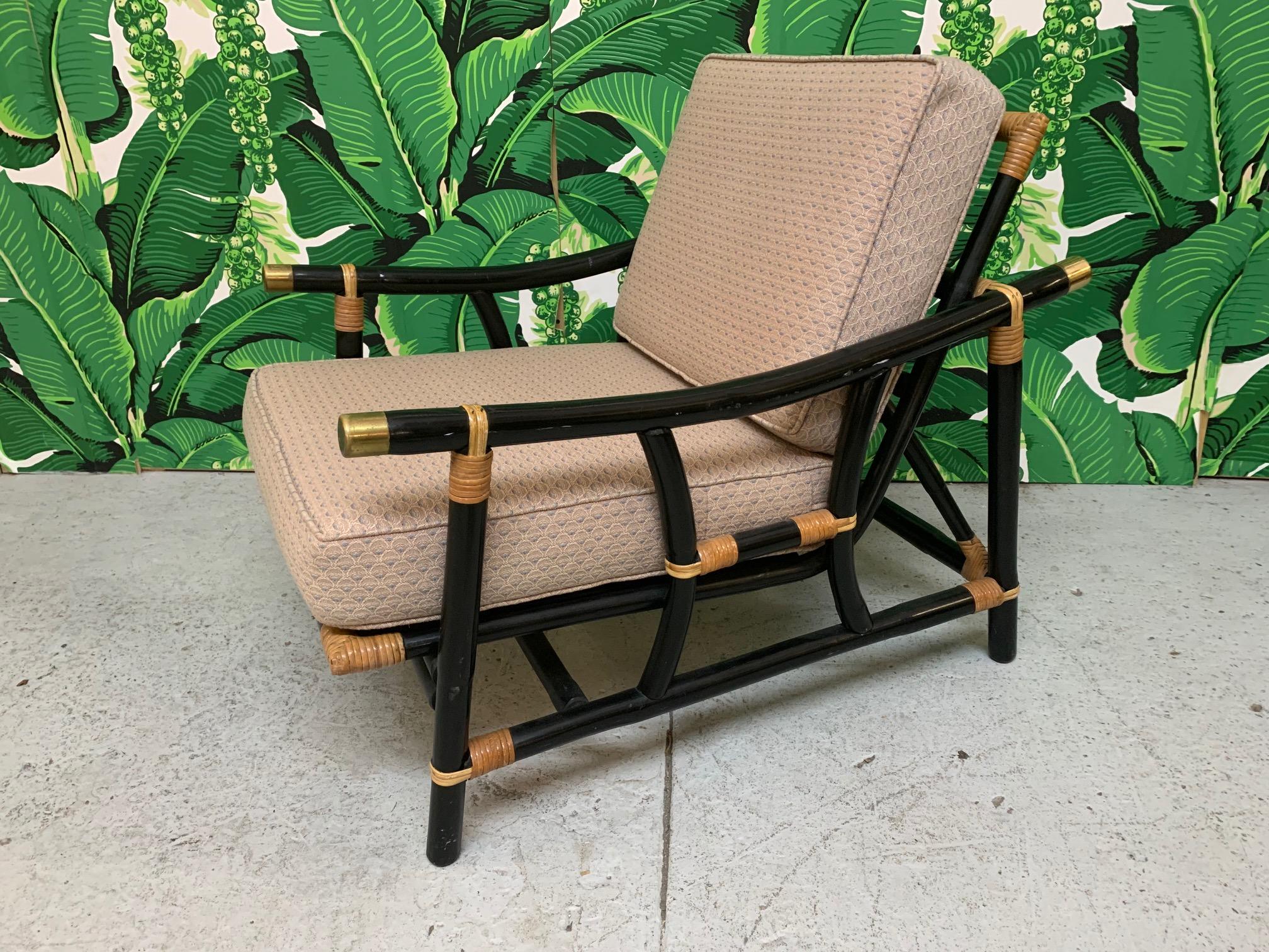 Rattan lounge chair features striking black finish with tan strapping. In the style of McGuire.
Very good condition with only minor imperfections consistent with age.  S8841