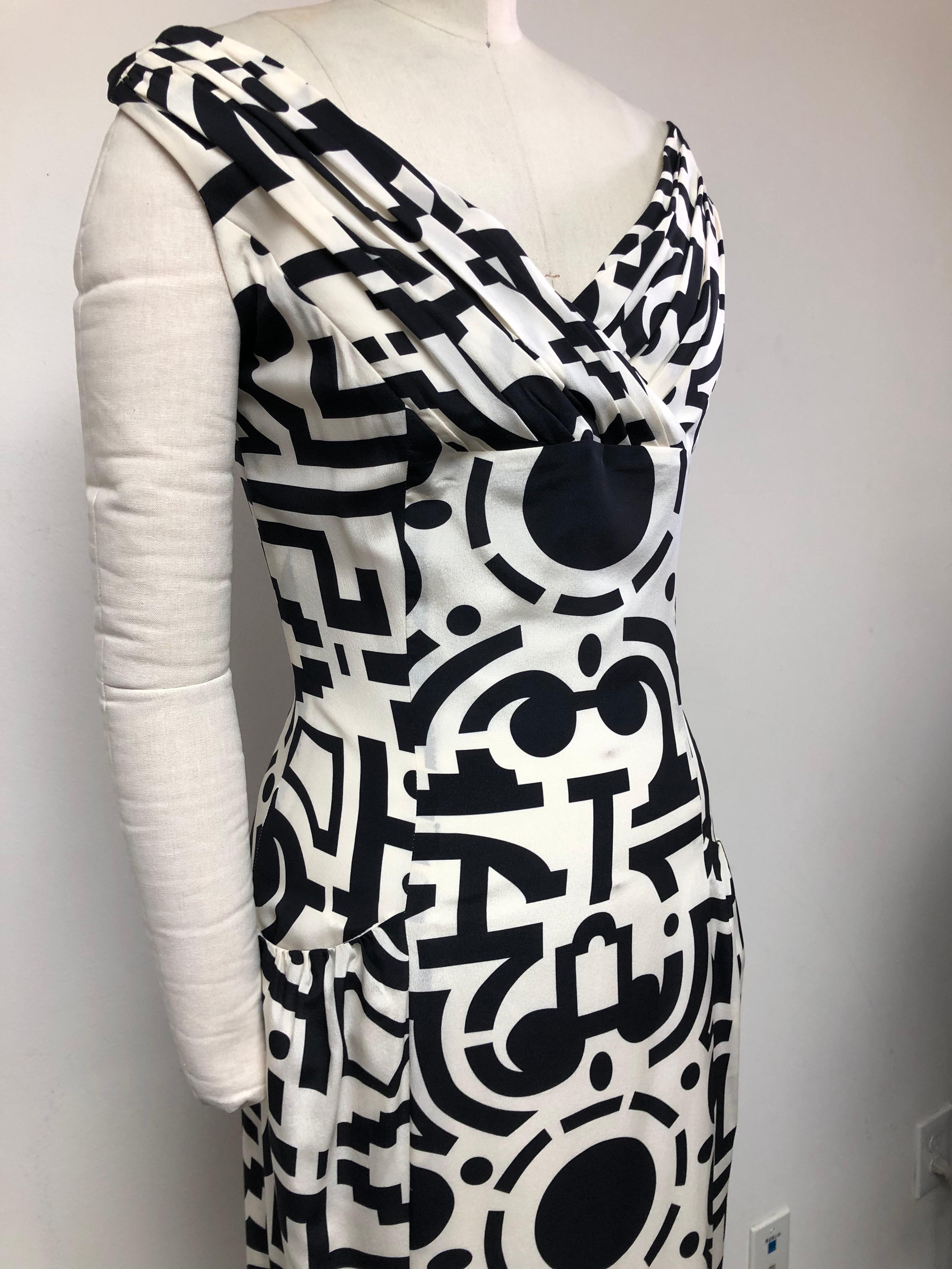 Black and White Topiary Garden Plan makes for a charming party dress. Gathered V neck off the shoulder bodice and side pockets.
Perfect for a garden party or black tie.
Crepe de chine 100% Silk from Frontline Zurich
maker of Hermes scarfs. A