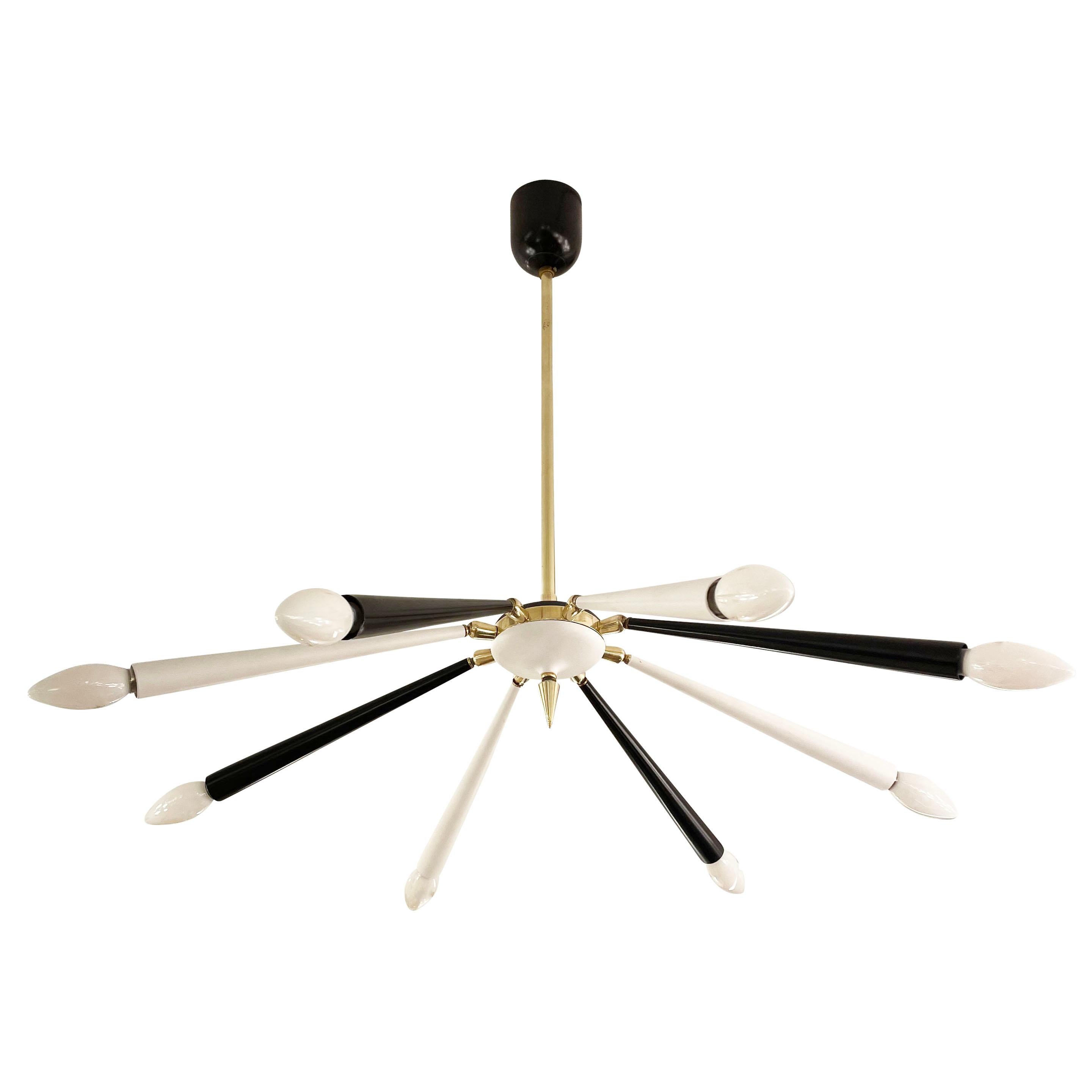 Italian mid-century chandelier with articulating black and white shades and brass details. The articulating joints allow the shades to be positioned in a variety of positions- we are showing it with all the shades slightly bent downwards. Holds