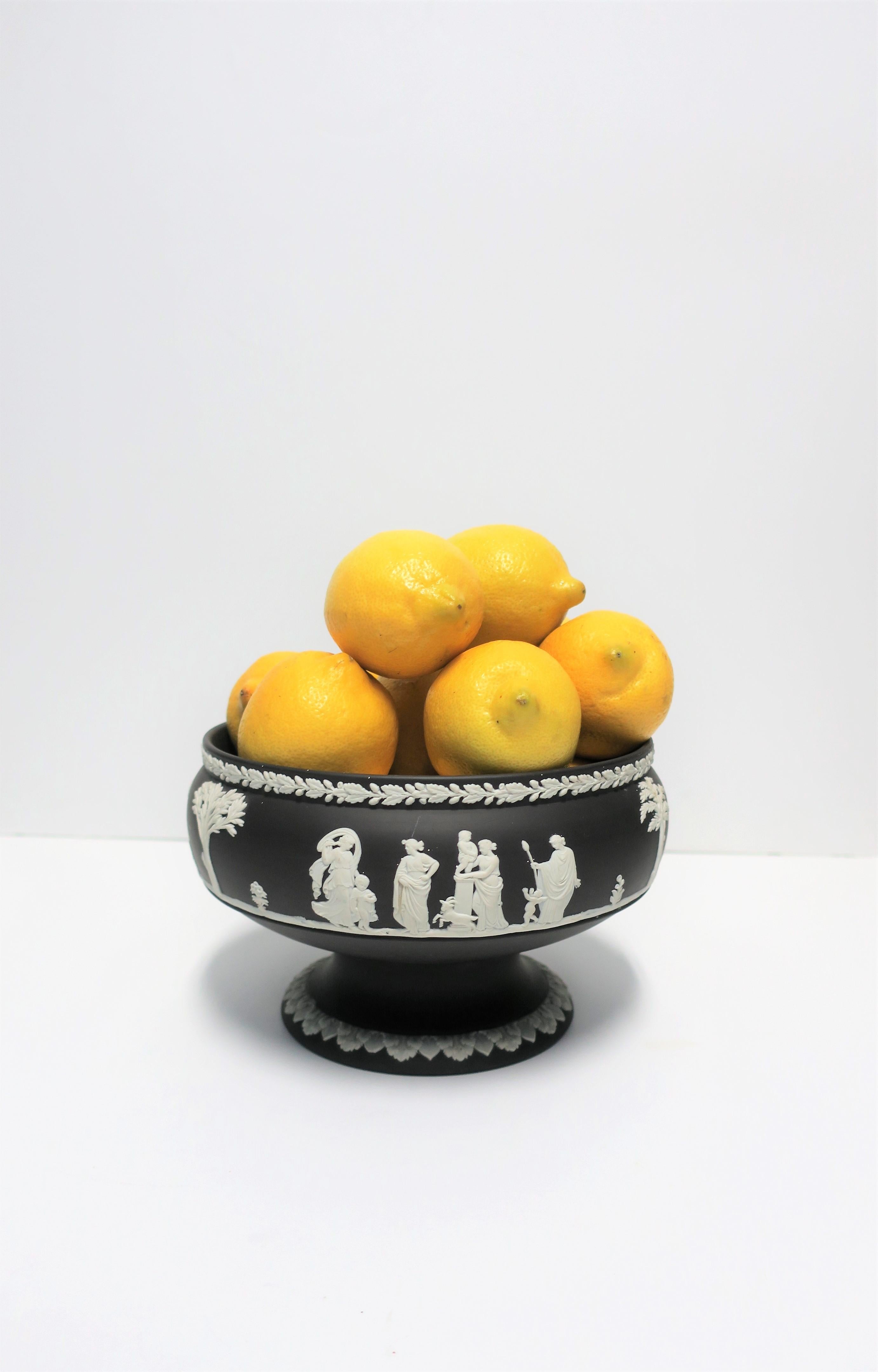 A beautiful detailed black and white Wedgwood Jasperware Neoclassical urn or centerpiece bowl vessel. Several raised relief scenes around bowl in white matte stoneware on top of black matte stoneware. With maker's mark underneath as show in images